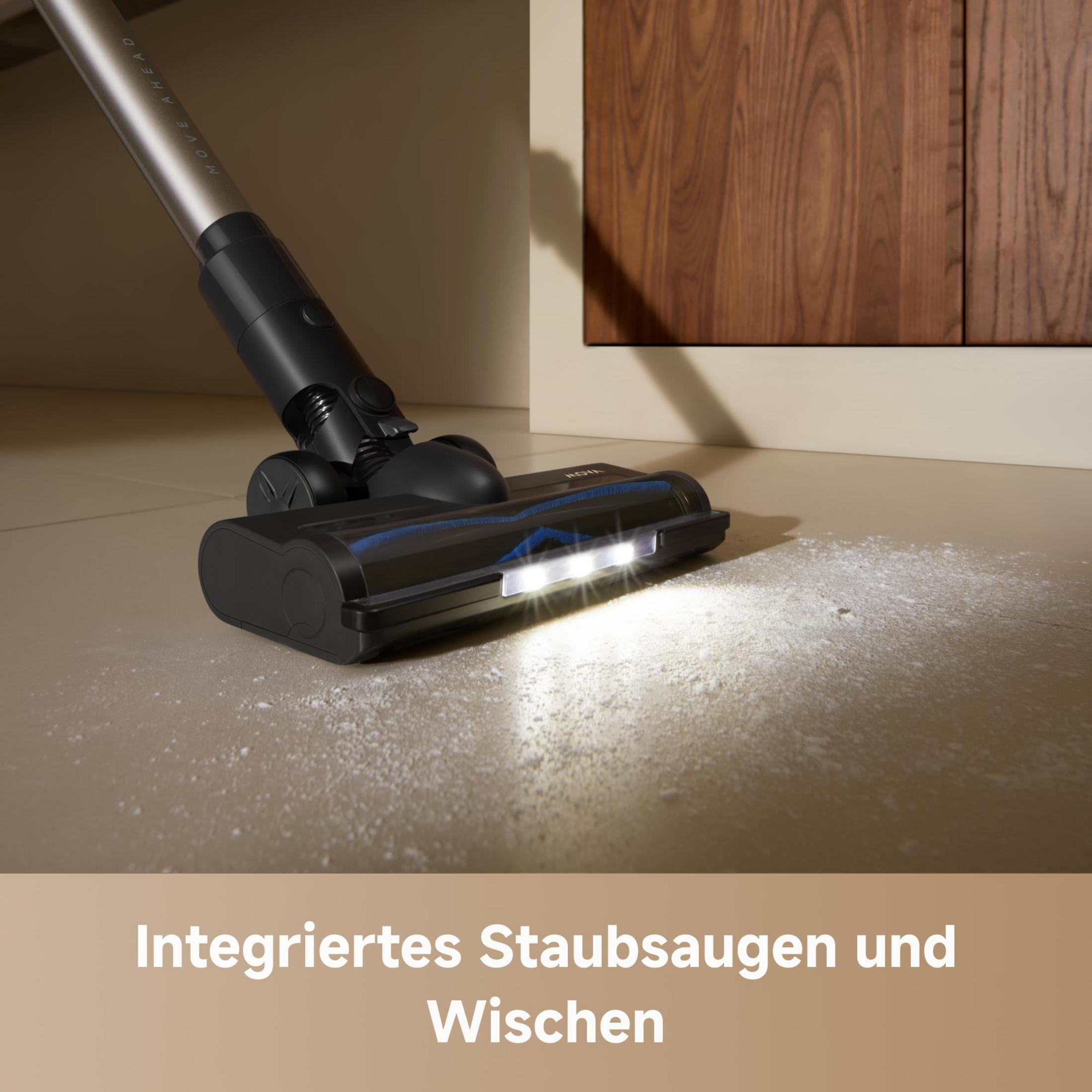 Testa di aspirapolvere nera con luci illuminate su un pavimento polveroso. Mobile in legno sullo sfondo.
