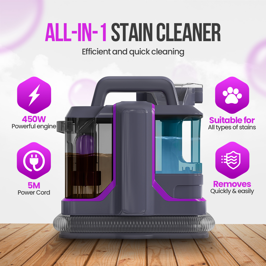 An all-in-one stain cleaner is displayed on a wooden surface. The cleaner is gray and purple, with icons for power, cord length, and stain removal.
