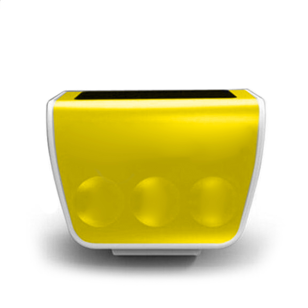 Un dispositivo giallo con tre pulsanti circolari e una parte superiore nera. Ha un bordo bianco e poggia su una base bianca.