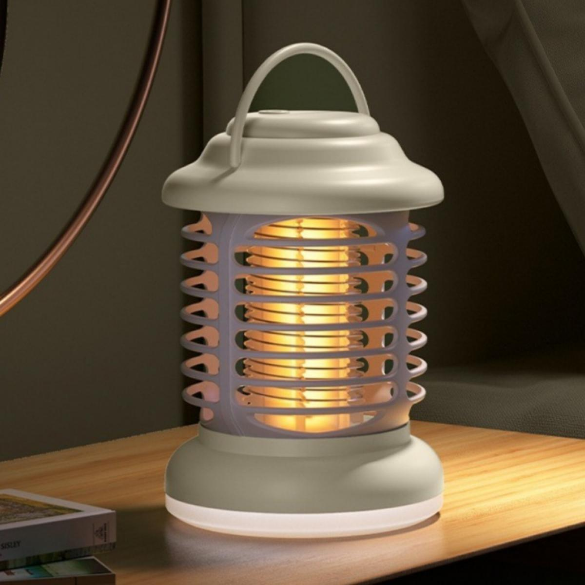 Eine graue Insektenvernichter-Lampe mit Griff steht auf einer Holzoberfläche. Die Lampe leuchtet und zeigt ein gelbes Glimmen. Dunkler Hintergrund.