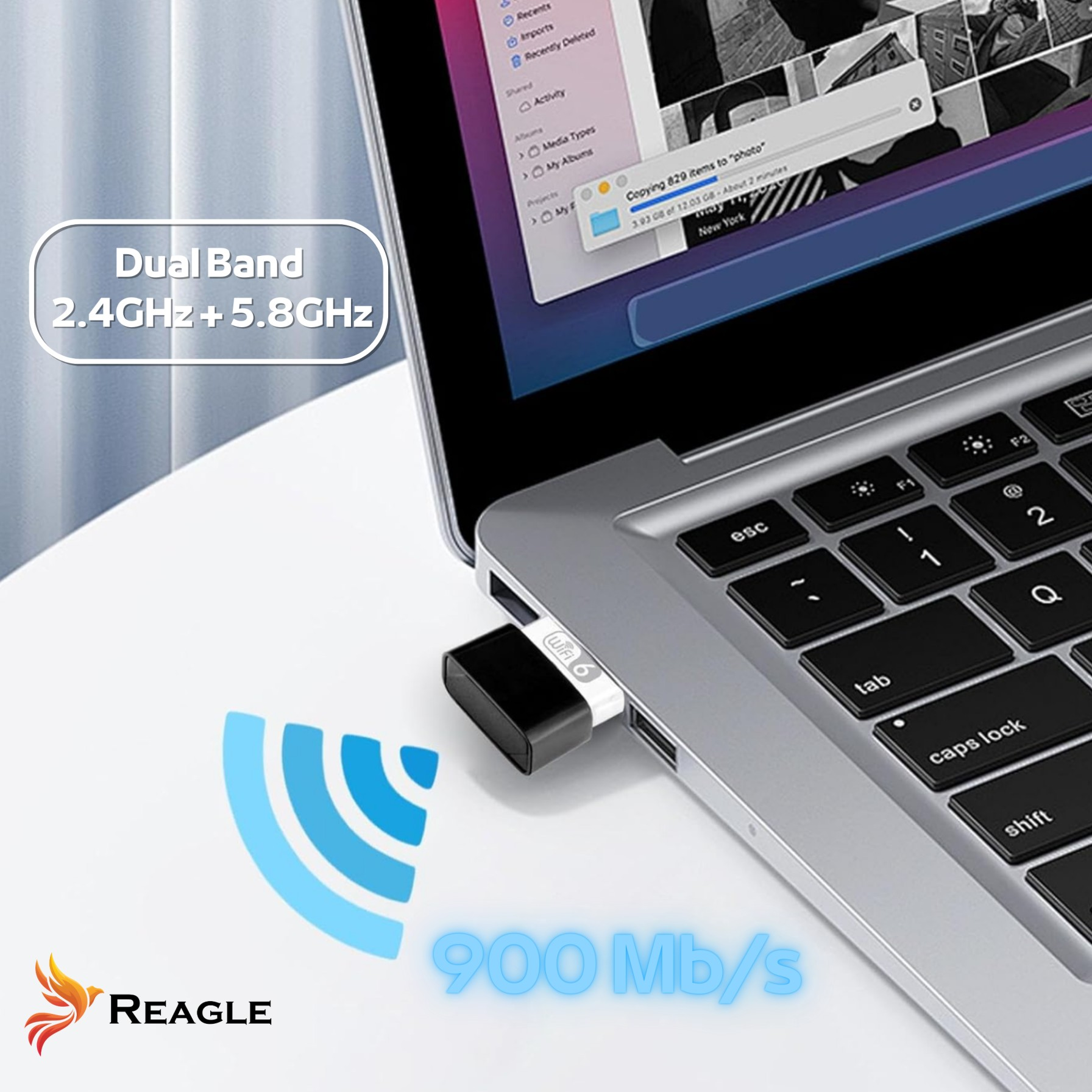 Laptop mit WiFi 6-Adapter, der Dateien kopiert. Dualband, 900 Mb/s und Reagle-Branding sind sichtbar.