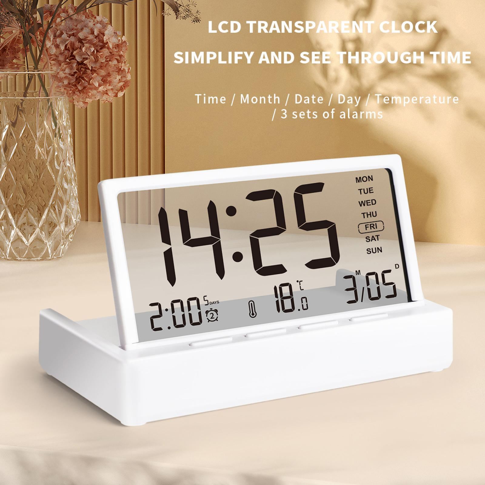 Eine weiße LCD-Transparentuhr zeigt Zeit, Datum und Temperatur an. Die Uhrzeit ist 14:25. Die Uhr steht auf einem weißen Ständer.