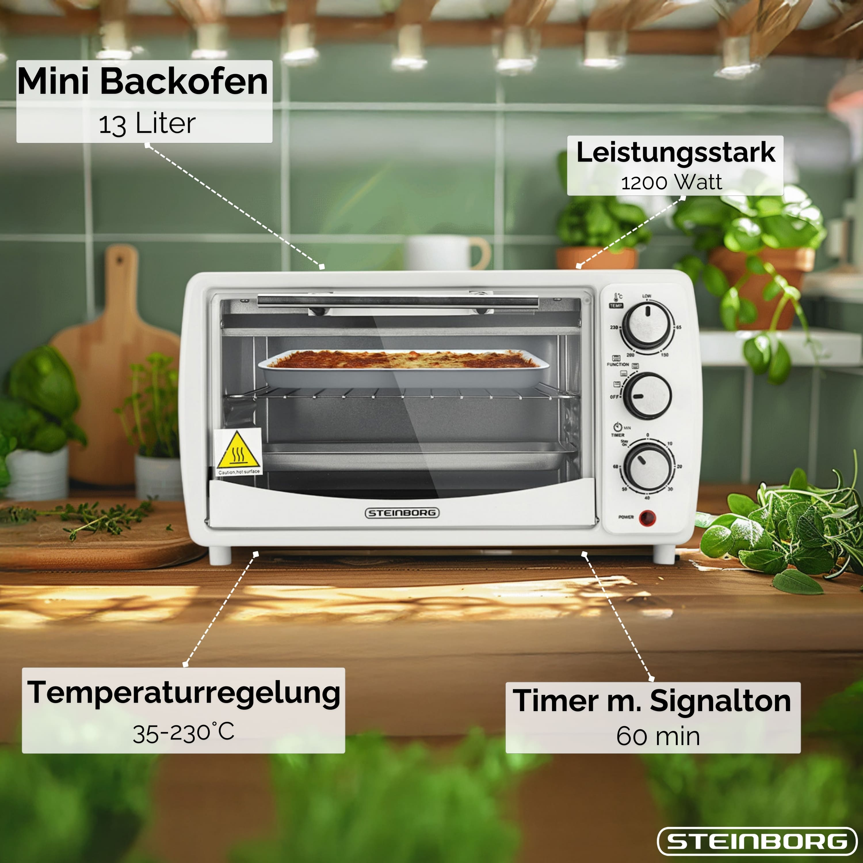 Ein weißer Mini-Backofen mit einem Tablett mit Essen. Es hat Knöpfe und einen Timer. Zutaten und Pflanzen im Hintergrund.