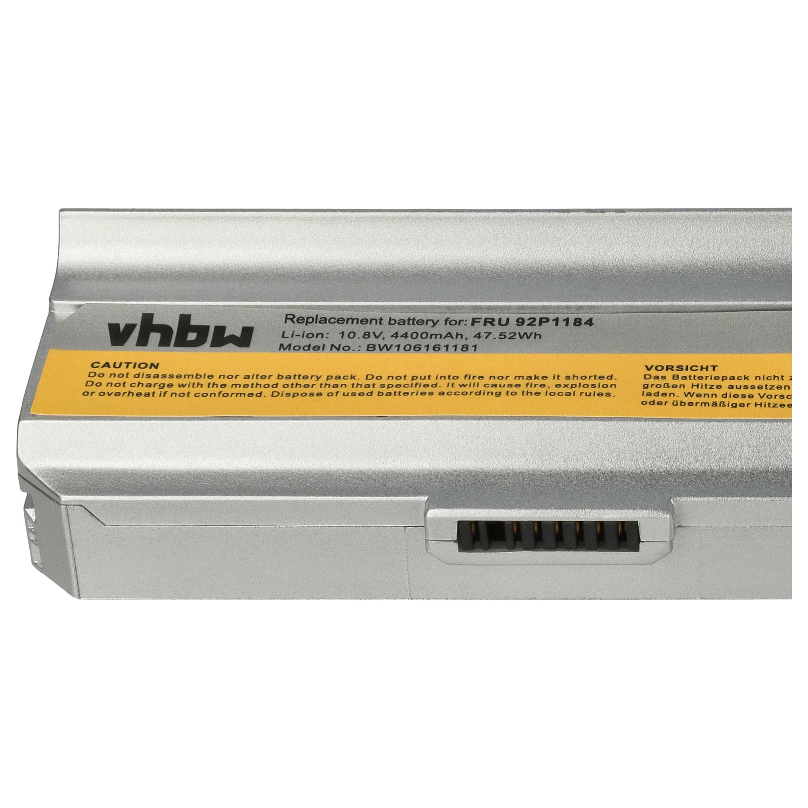 Silberner Laptop-Akku mit gelbem Etikett. Text enthält 'Ersatzbatterie' und Warnungen.