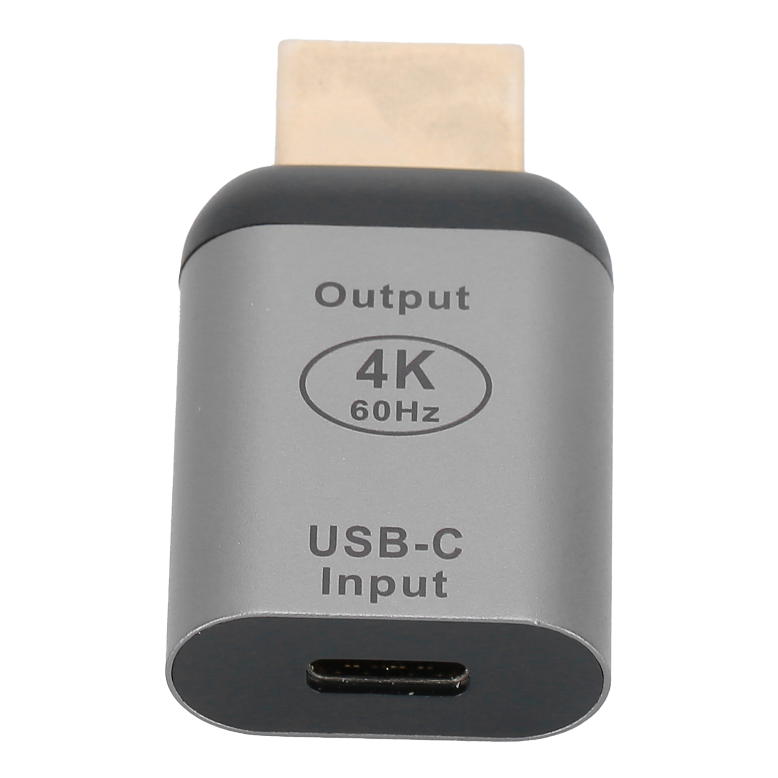 Ein silberner USB-C-zu-HDMI-Adapter. Er trägt die Aufschrift 'Output', '4K 60Hz' und 'USB-C Input'. Die Oberseite ist beige.