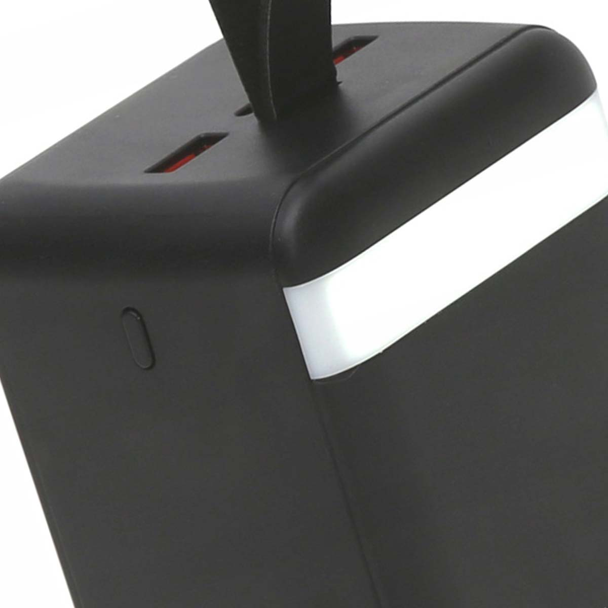 Ein schwarzes Netzteil mit weißem Streifen und einem schwarzen Griff. Der Adapter hat zwei Anschlüsse mit roter Innenseite. Der Hintergrund ist unscharf.