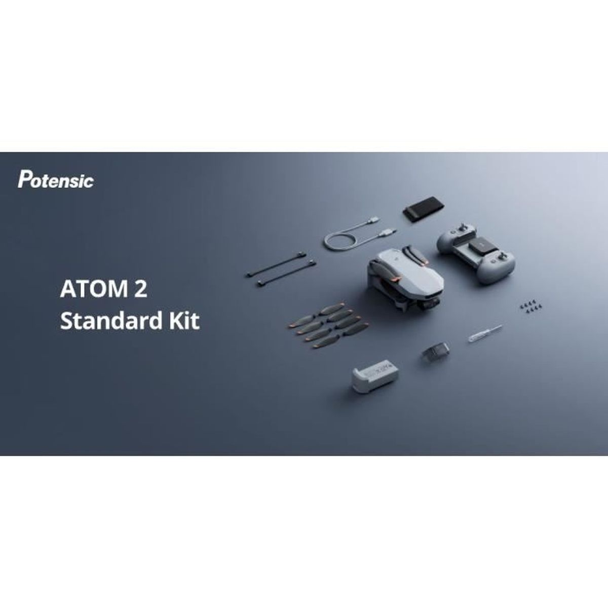 Zestaw Potensic ATOM 2 Standard Kit na szarej powierzchni. Zawiera drona, pilota, śmigła, baterię, kable i inne akcesoria.