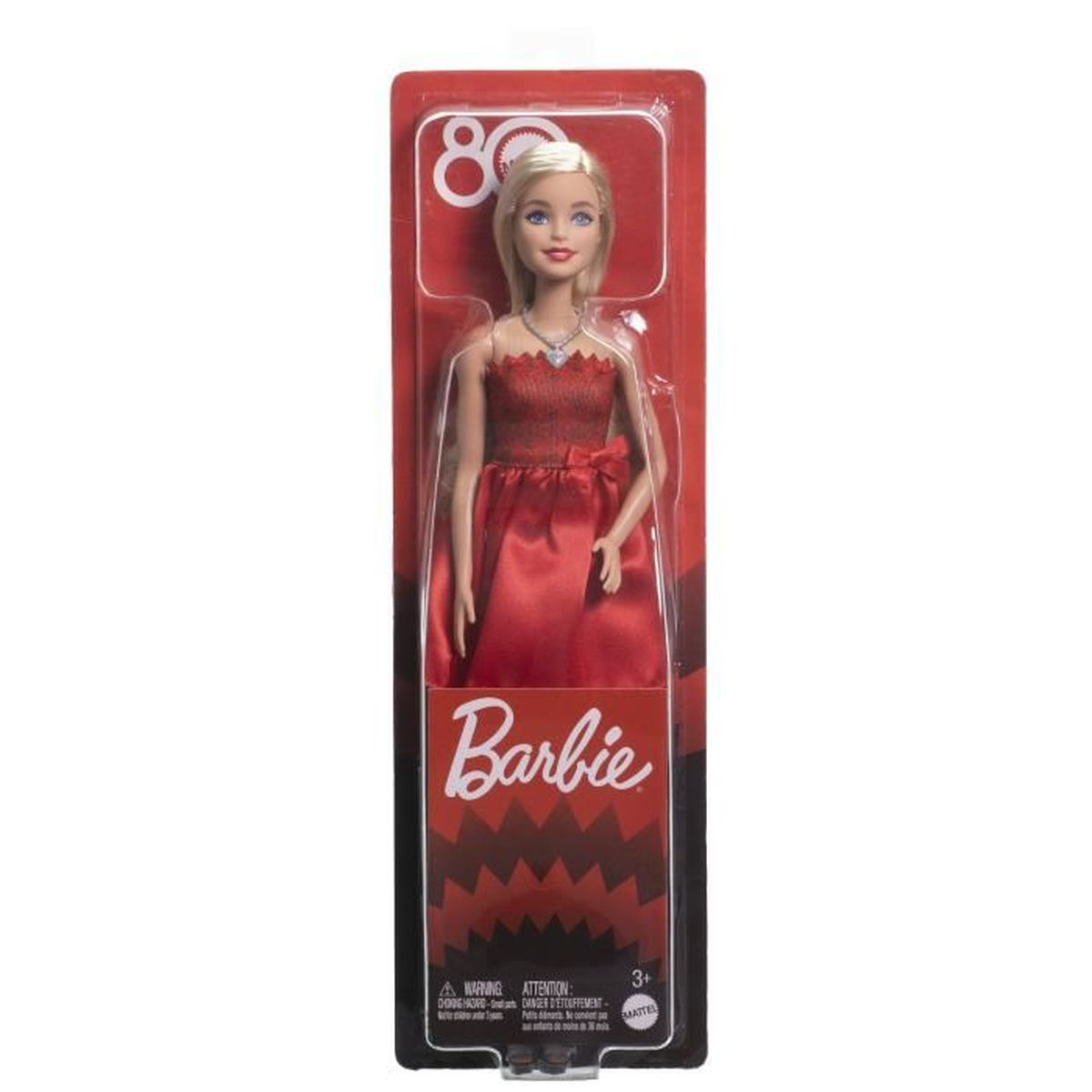 Eine Barbie-Puppe in einem roten Kleid wird in der Verpackung gezeigt. Die Puppe hat blondes Haar und eine Halskette. Die Verpackung hat das Barbie-Logo.