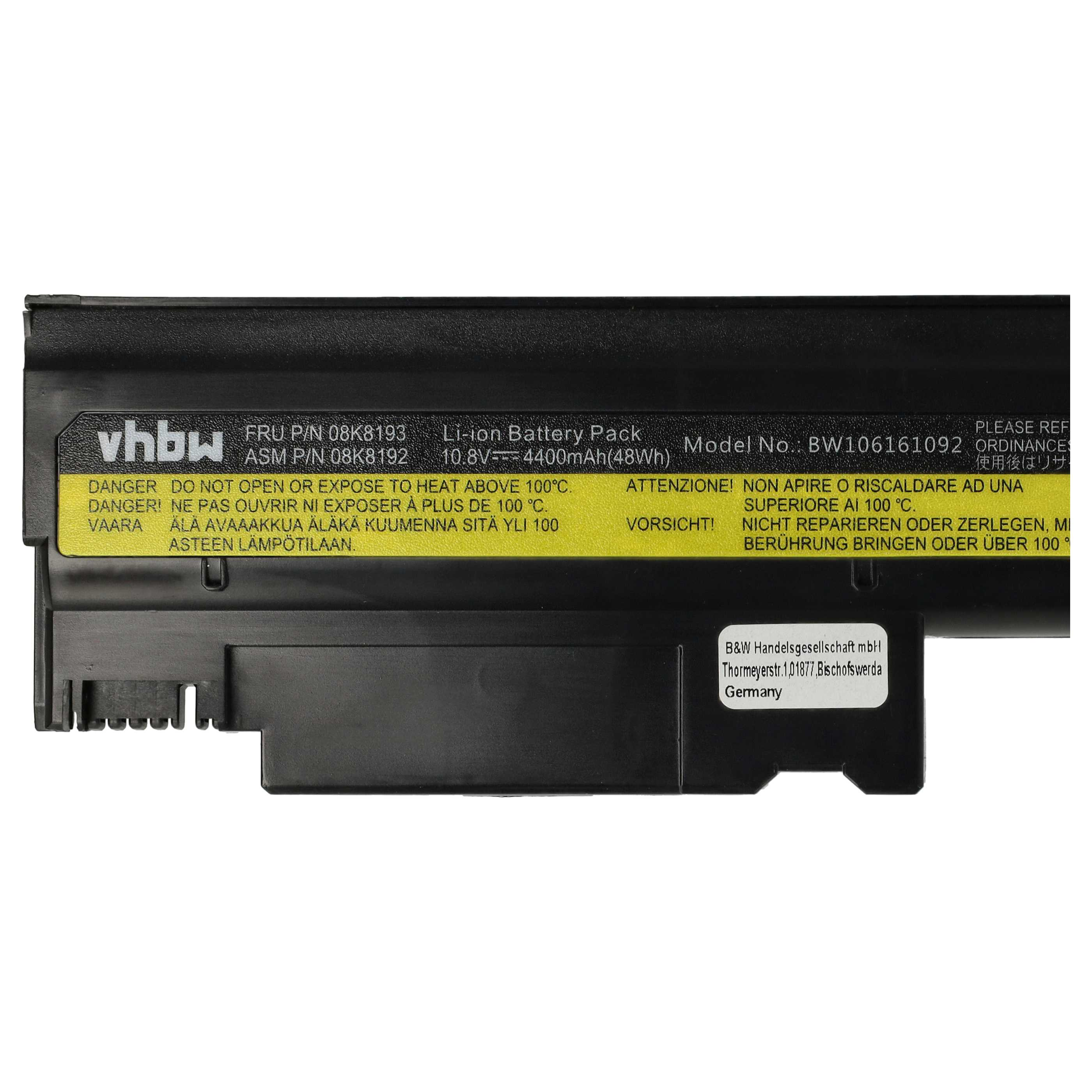 Una batteria nera per laptop con avvertenze in più lingue.