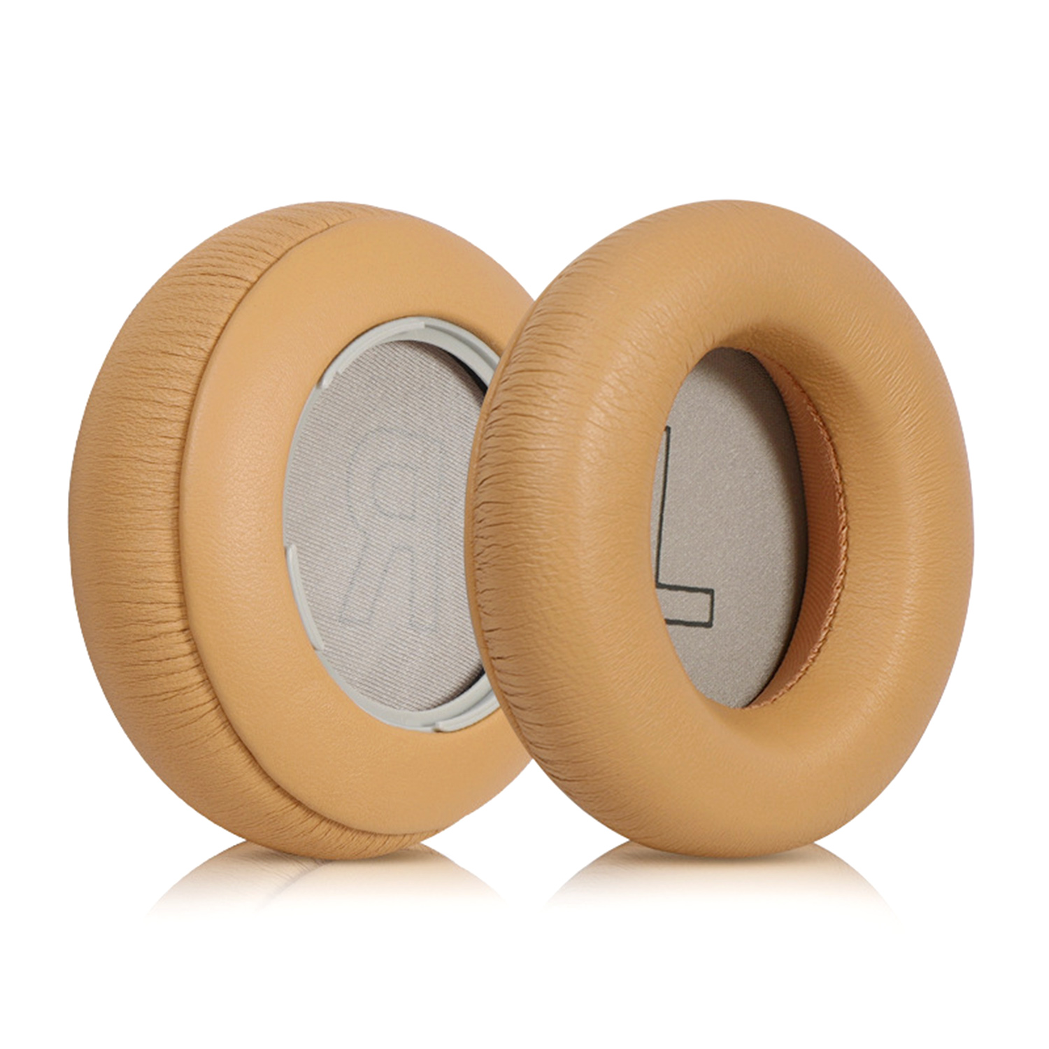 Dwie brązowo-żółte poduszki na uszy słuchawek, jedna skierowana do widza, druga nieco za nią, na białym tle.