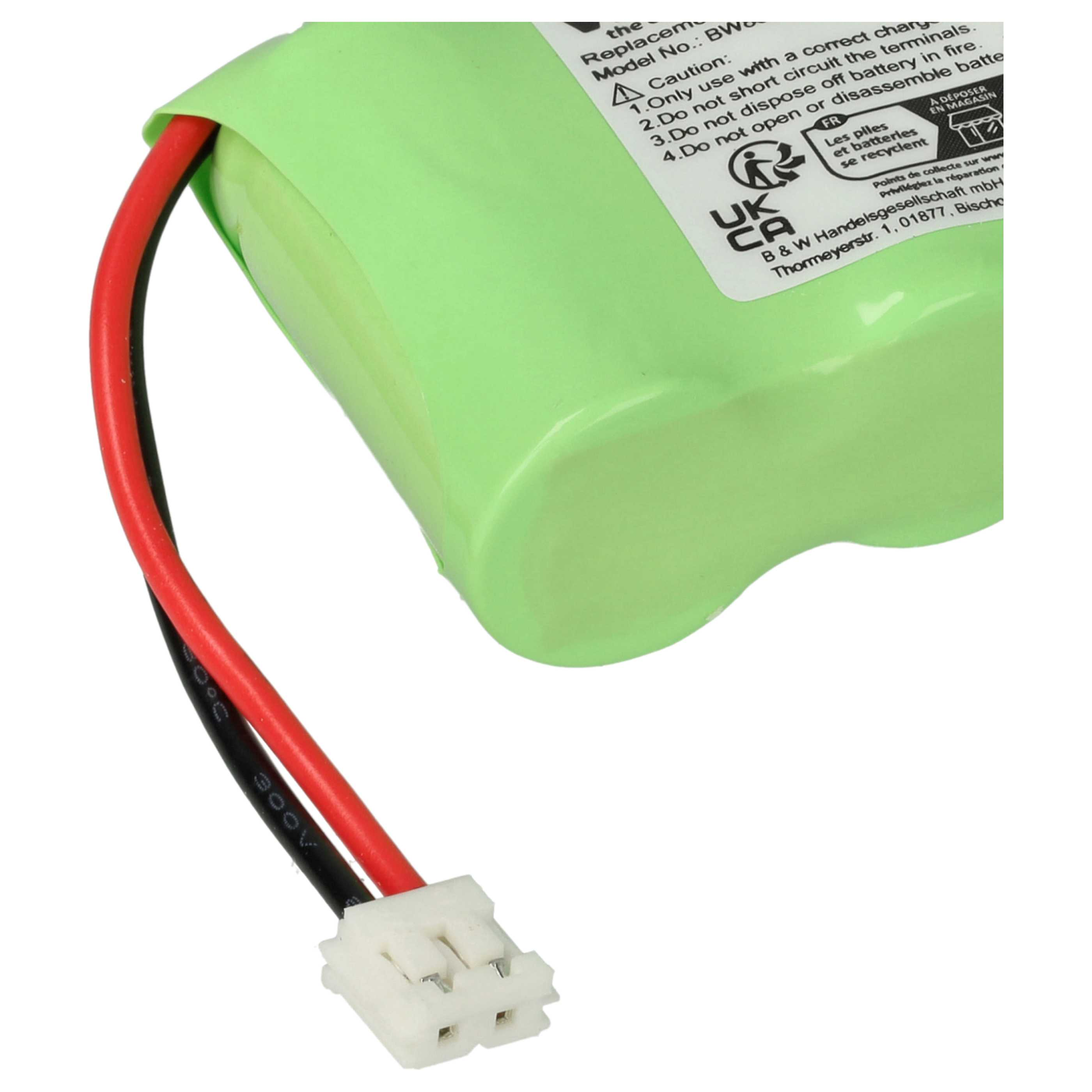 Eine grüne Batterie mit schwarzen und roten Drähten, die an einem weißen Stecker befestigt sind. Text im Hintergrund.