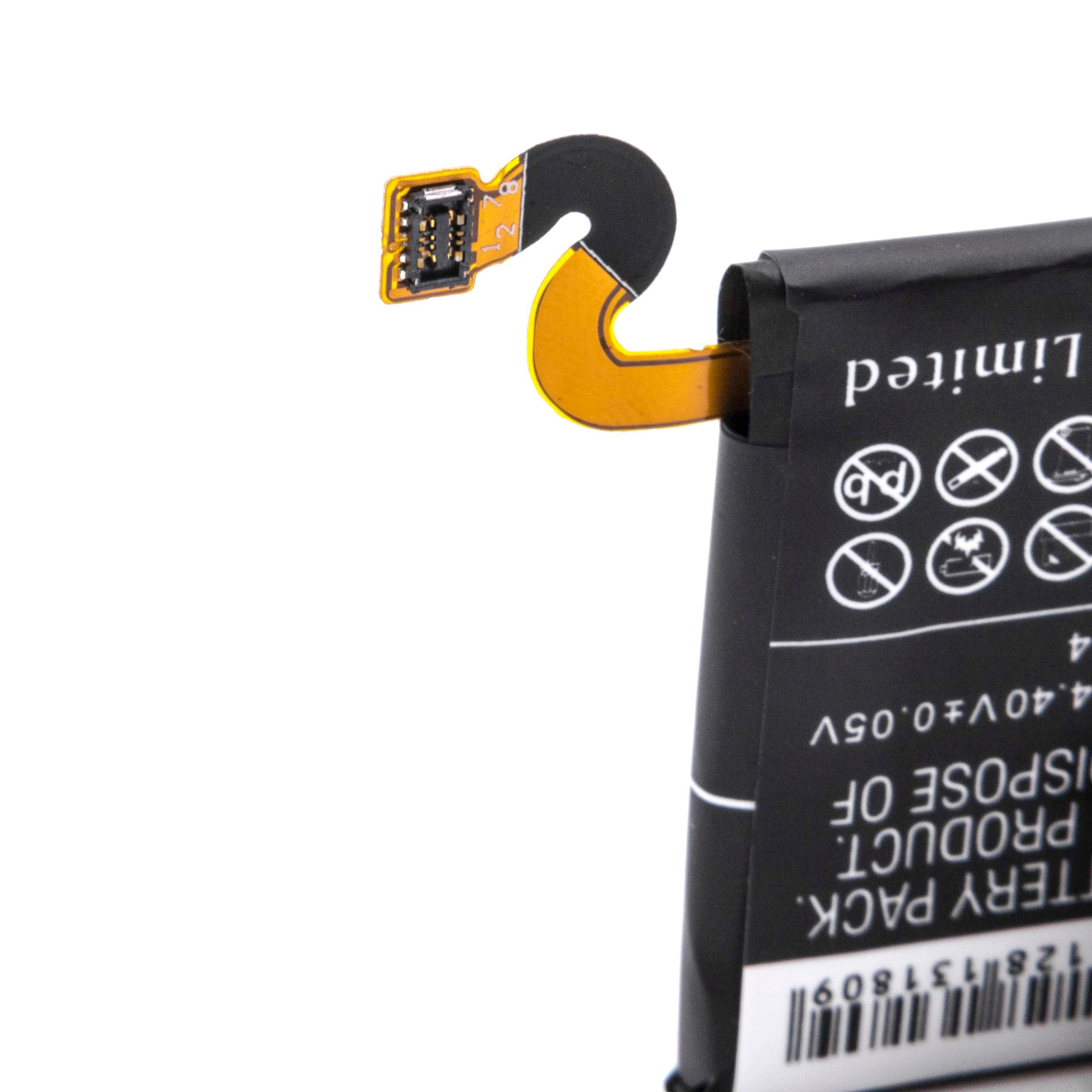 Nahaufnahme eines Akkus mit einem angeschlossenen Flexkabel. Der Akku ist schwarz, das Kabel gelb. Etiketten sind sichtbar.