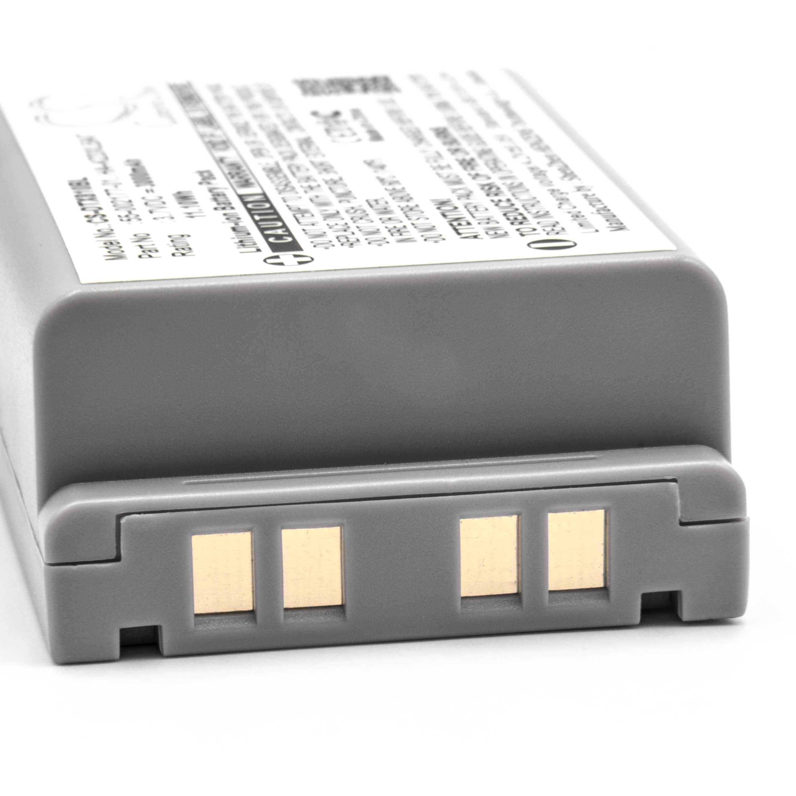 Ein graues Batteriepack mit goldenen Kontaktpunkten liegt auf einer weißen Oberfläche. Textlabels sind sichtbar.