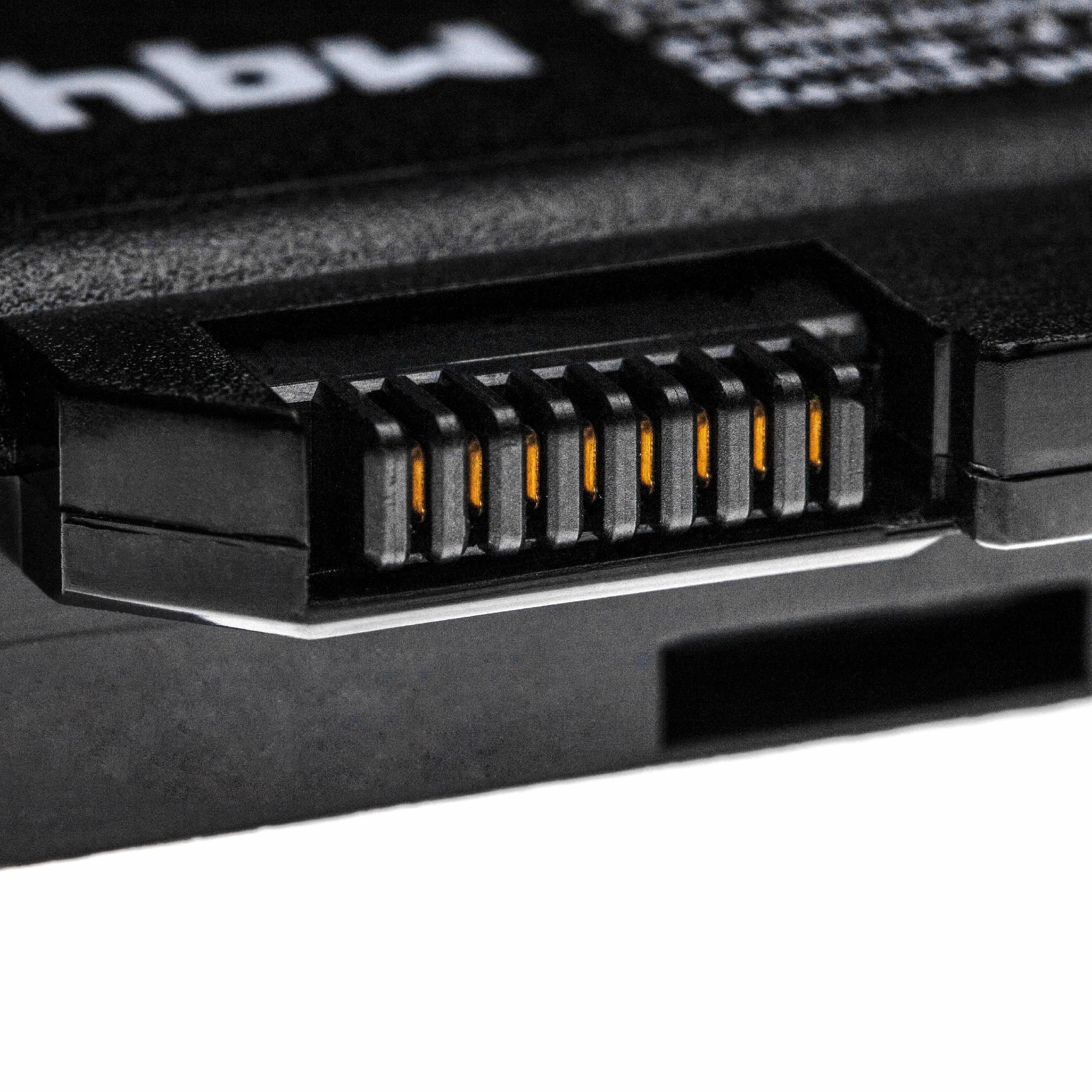 Nahaufnahme einer schwarzen elektronischen Komponente mit goldfarbenen Pins. Die Komponente liegt vor weißem Hintergrund.
