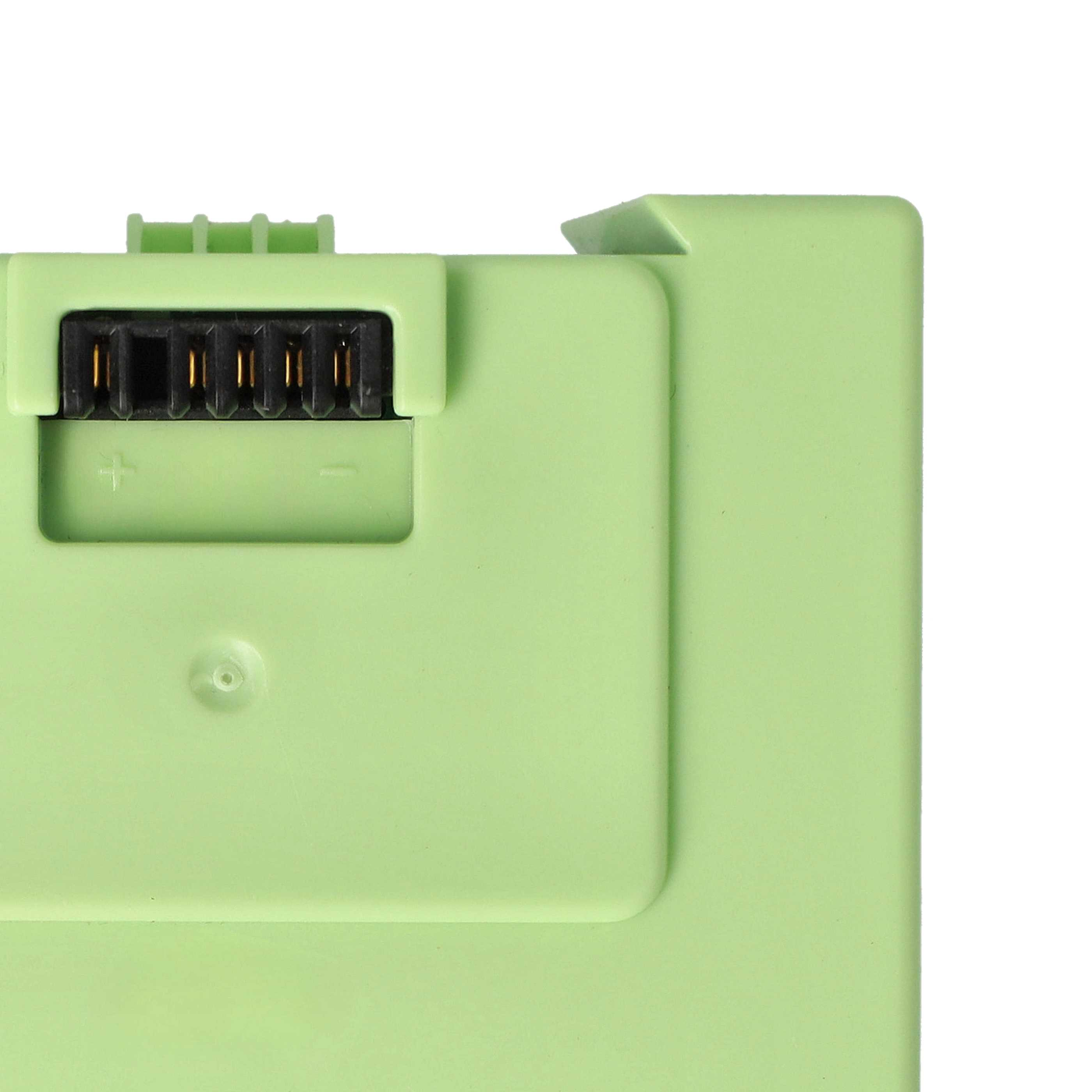 Nahaufnahme eines hellgrünen Objekts mit einem schwarzen Stecker. Der Stecker hat goldene Stifte. Weißer Hintergrund.