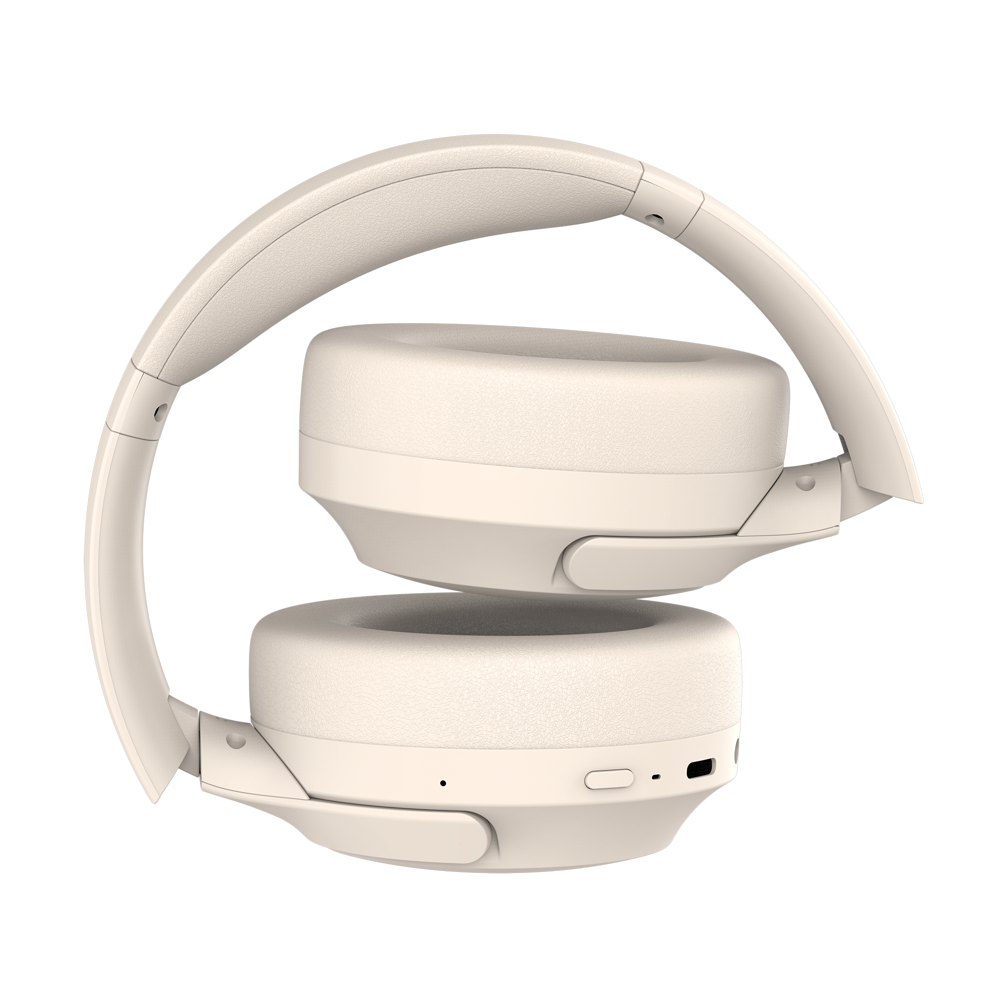 Kremowe słuchawki, złożone. Muszle są okrągłe, pałąk wygięty. Przyciski i port widoczne.