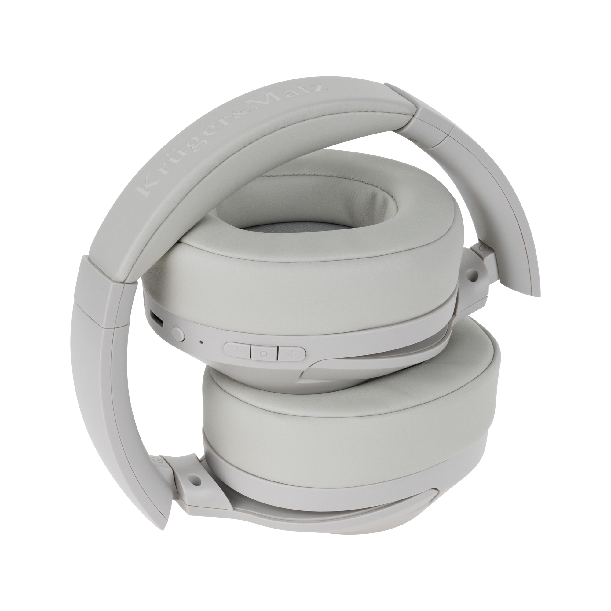 Złożone, jasnoszare słuchawki z napisem 'Krüger&Matz' na pałąku. Przyciski są widoczne z boku.