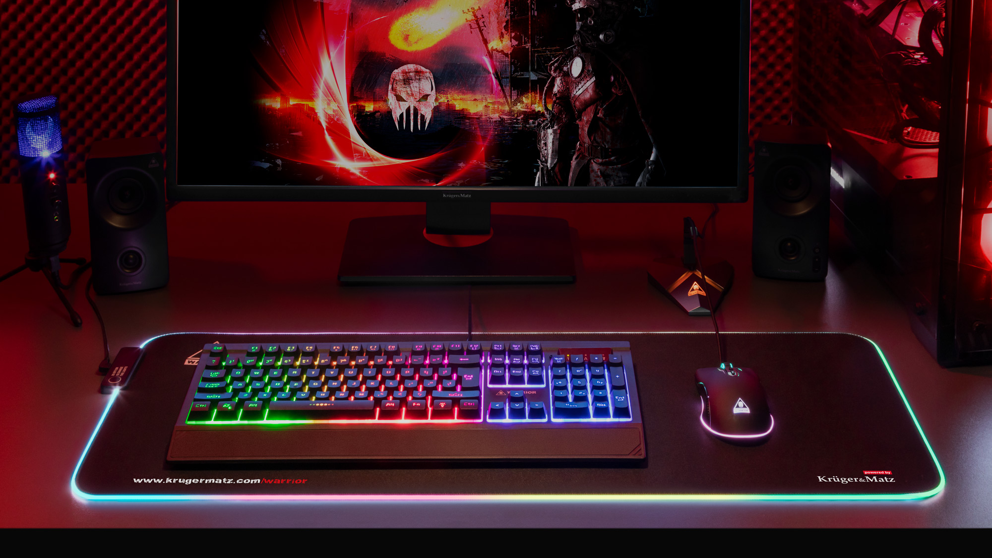 Konfiguracja do gier z klawiaturą, myszą i monitorem. Klawiatura ma kolorowe światła. Tło przedstawia ciemny obraz.