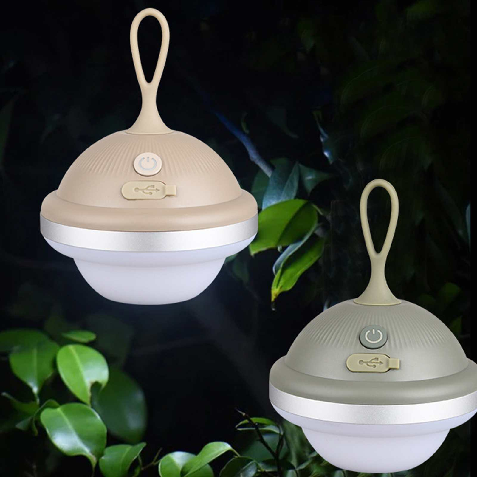 Zwei beige und graue Lampen mit Schlaufengriff, Ein-/Ausschalter und USB-Anschluss vor grünem Laub.