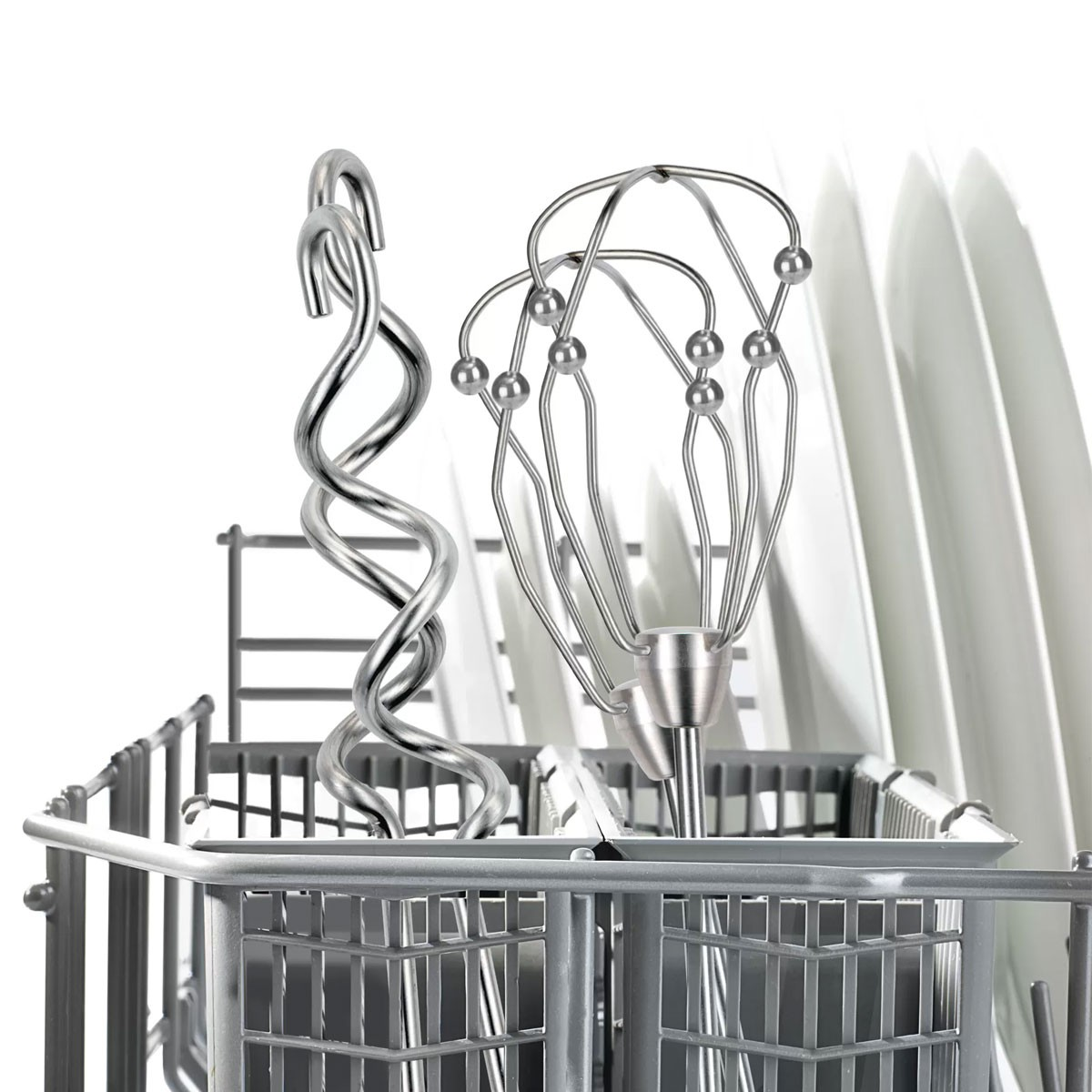 Close-up of a dishwasher rack with metallic, spiral utensils, a whisk, and white plates. The rack is gray, plates are white.