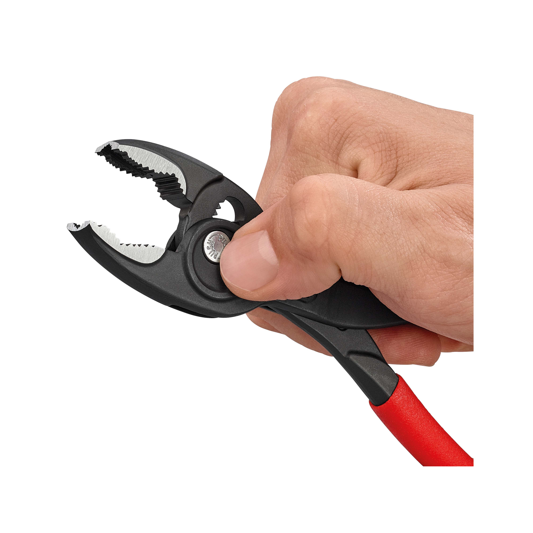 Dłoń trzyma czarne szczypce z czerwonym uchwytem. Szczypce są otwarte, pokazując zęby. Białe tło.