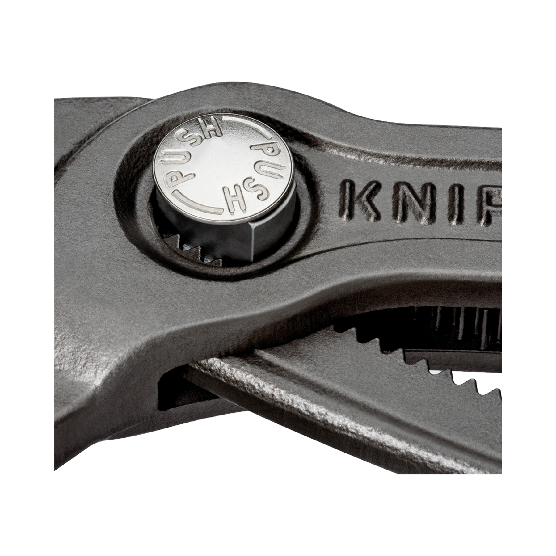 Zbliżenie czarno-srebrnego narzędzia. Widoczny jest przycisk z napisami 'PUSH' i 'HS'.