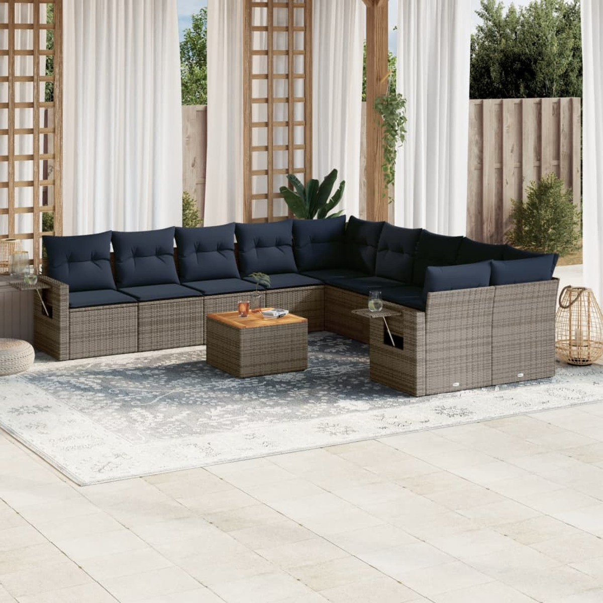 Outdoor-Ecksofa mit marineblauen Kissen und einem Holztisch auf einem gemusterten Teppich, in der Nähe von Vorhängen und einer Holzstruktur.
