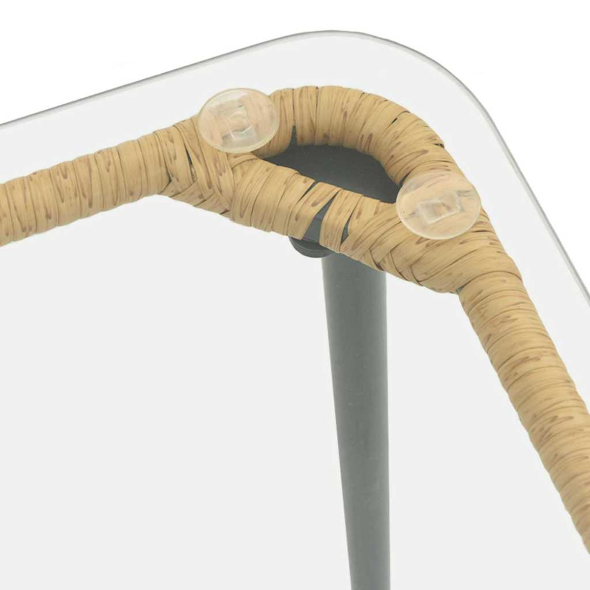 Primer plano de una esquina de silla. El marco está envuelto en mimbre marrón claro, soportando una superficie de vidrio. Son visibles dos topes redondos y transparentes.