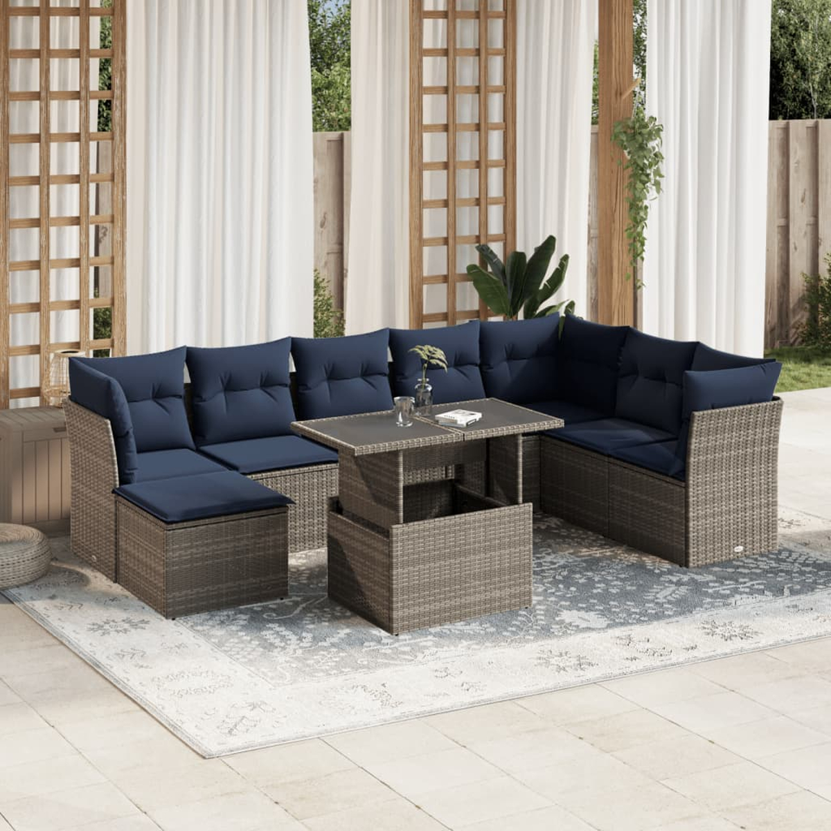 Outdoor-Ecksofa mit marineblauen Kissen und einem Tisch mit Hubfunktion auf einem gemusterten Teppich, unter einer Pergola.