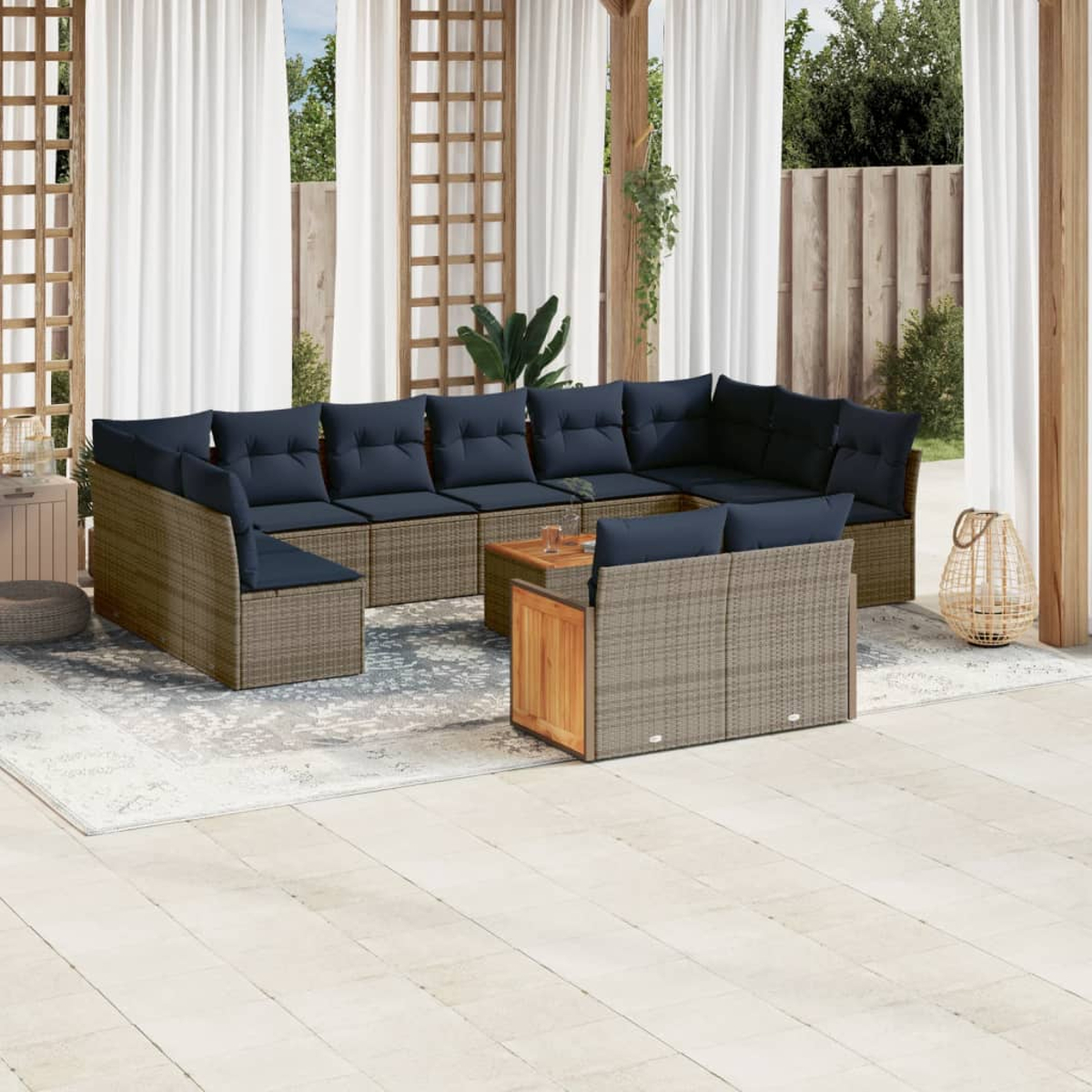 Outdoor-Sitzgruppe mit blauen Kissen. Enthält einen Couchtisch auf einem gemusterten Teppich und weiße Vorhänge im Hintergrund.