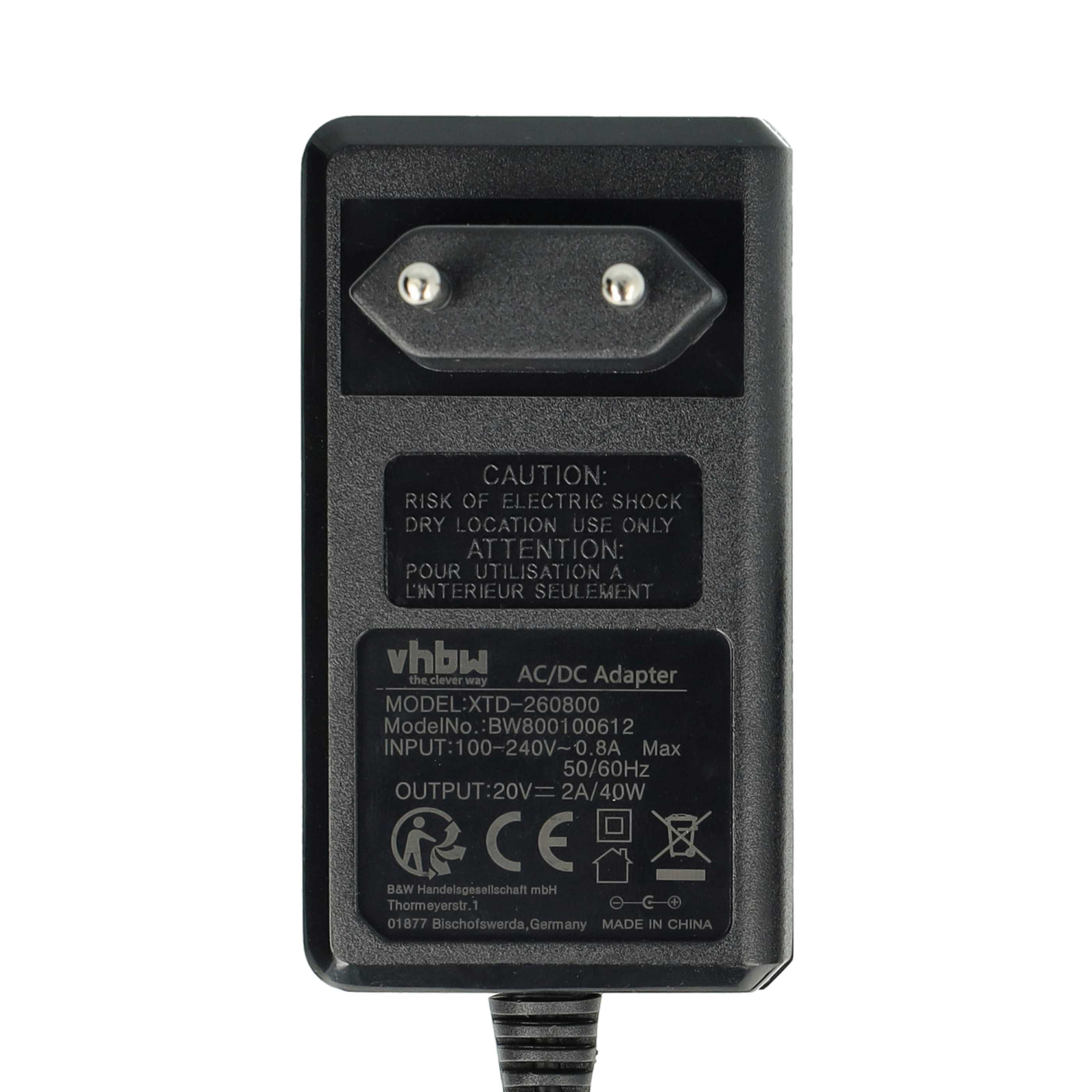 Schwarzes AC/DC-Netzteil mit Eurostecker, Warnhinweisen und technischen Daten. Details umfassen Eingangs- und Ausgangswerte.