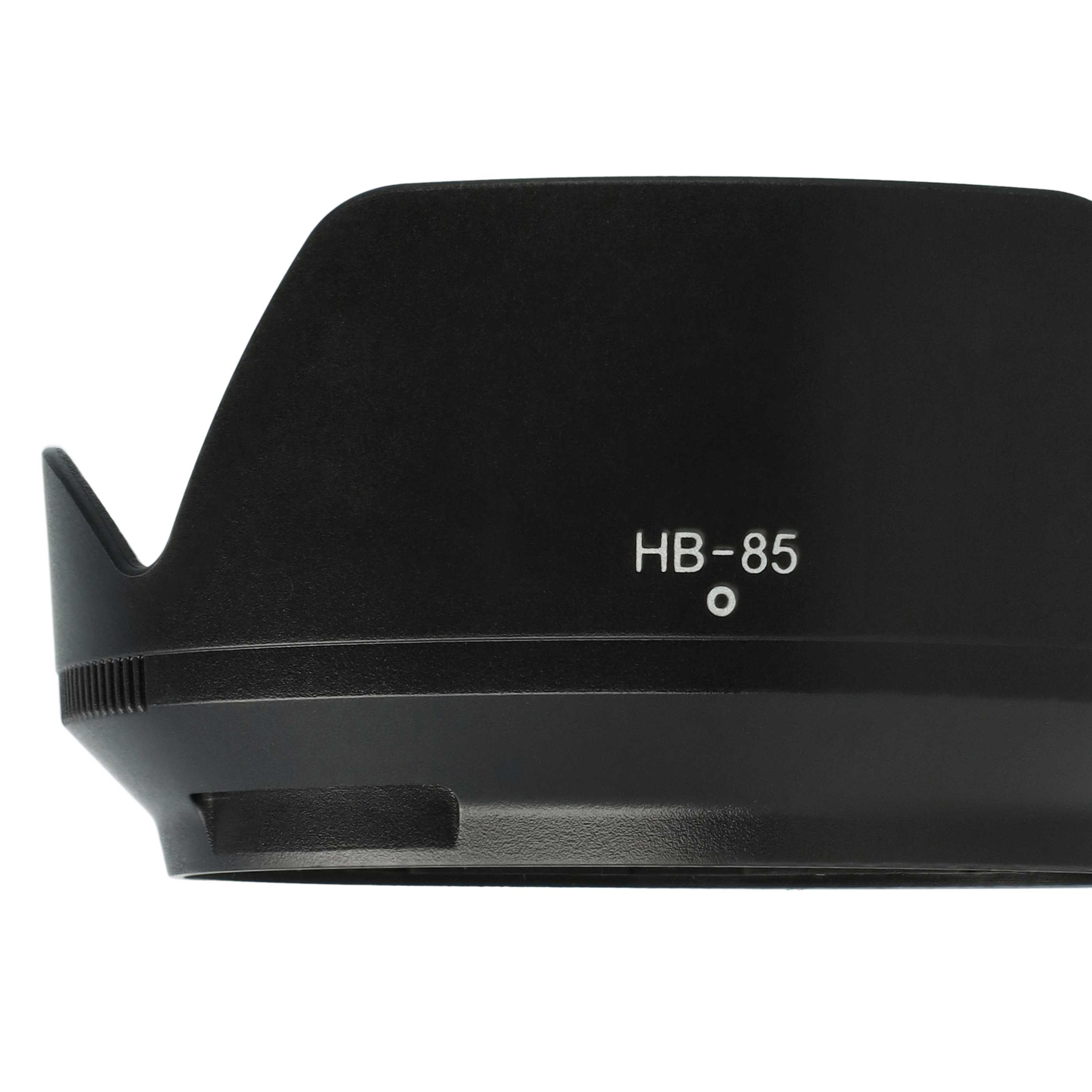 Eine schwarze Sonnenblende mit dem Text 'HB-85'. Sie befindet sich vor einem weißen Hintergrund. Die Haube ist zylindrisch und ausgestellt.