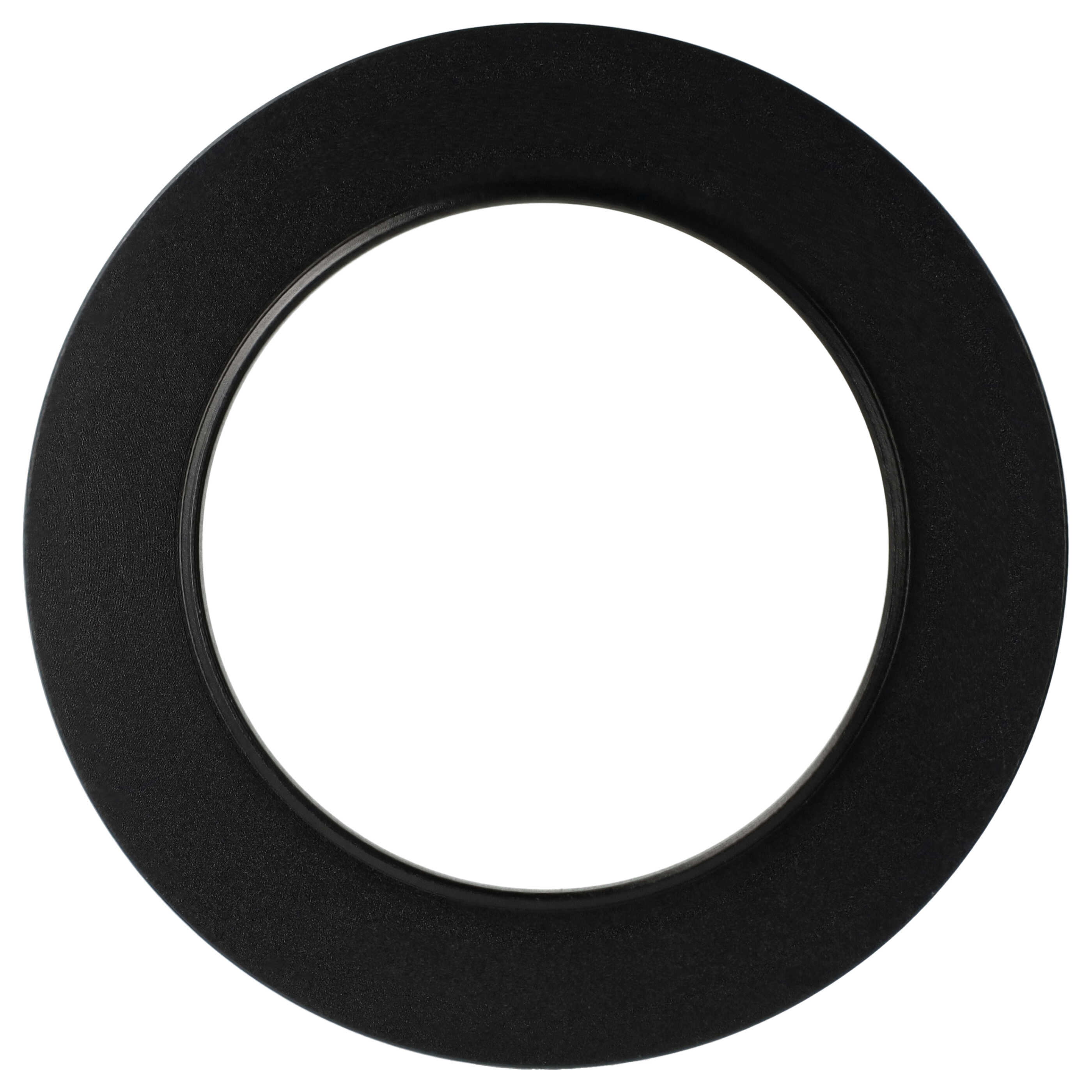 Ein schwarzes, kreisförmiges Objekt mit rauer Textur ist vor weißem Hintergrund zentriert. Das Objekt hat einen glatten Innenrand.