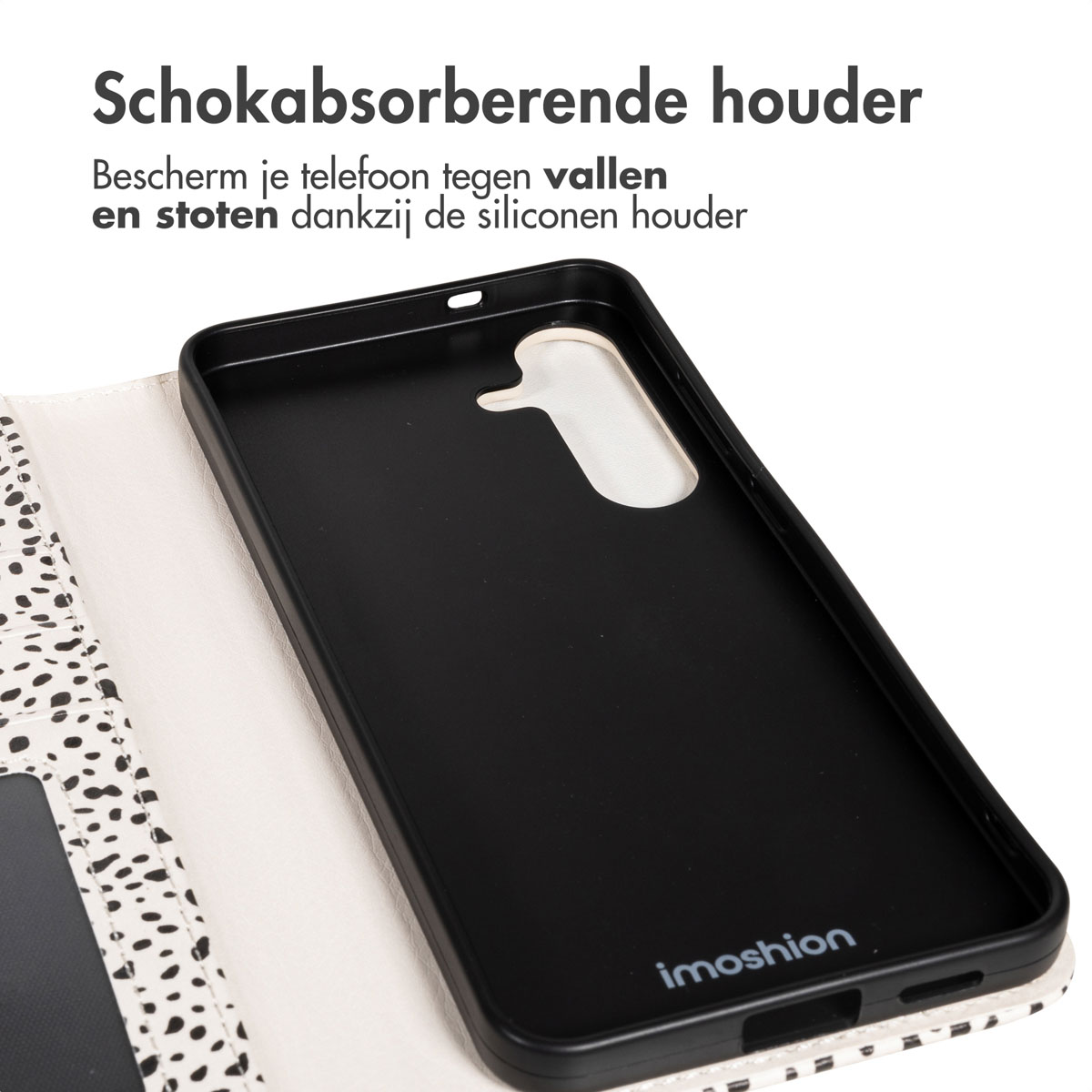 Zwarte telefoonhoes met een wit en zwart stippenpatroon. Tekst bovenaan beschrijft een schokabsorberende telefoonhouder.