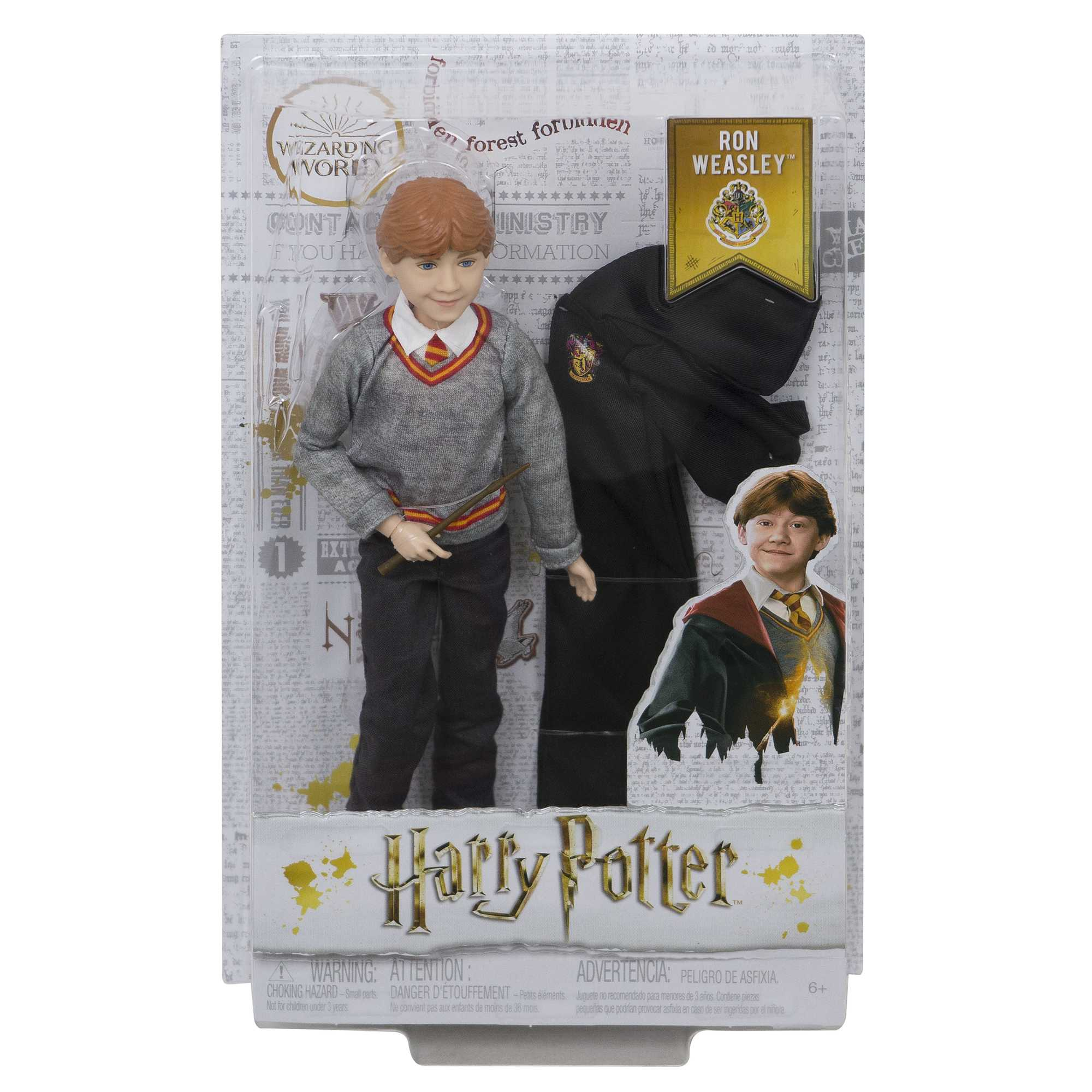 Eine Ron-Weasley-Puppe in einer Harry-Potter-Verpackung. Es zeigt die Puppe, einen Umhang und ein Bild von Ron.