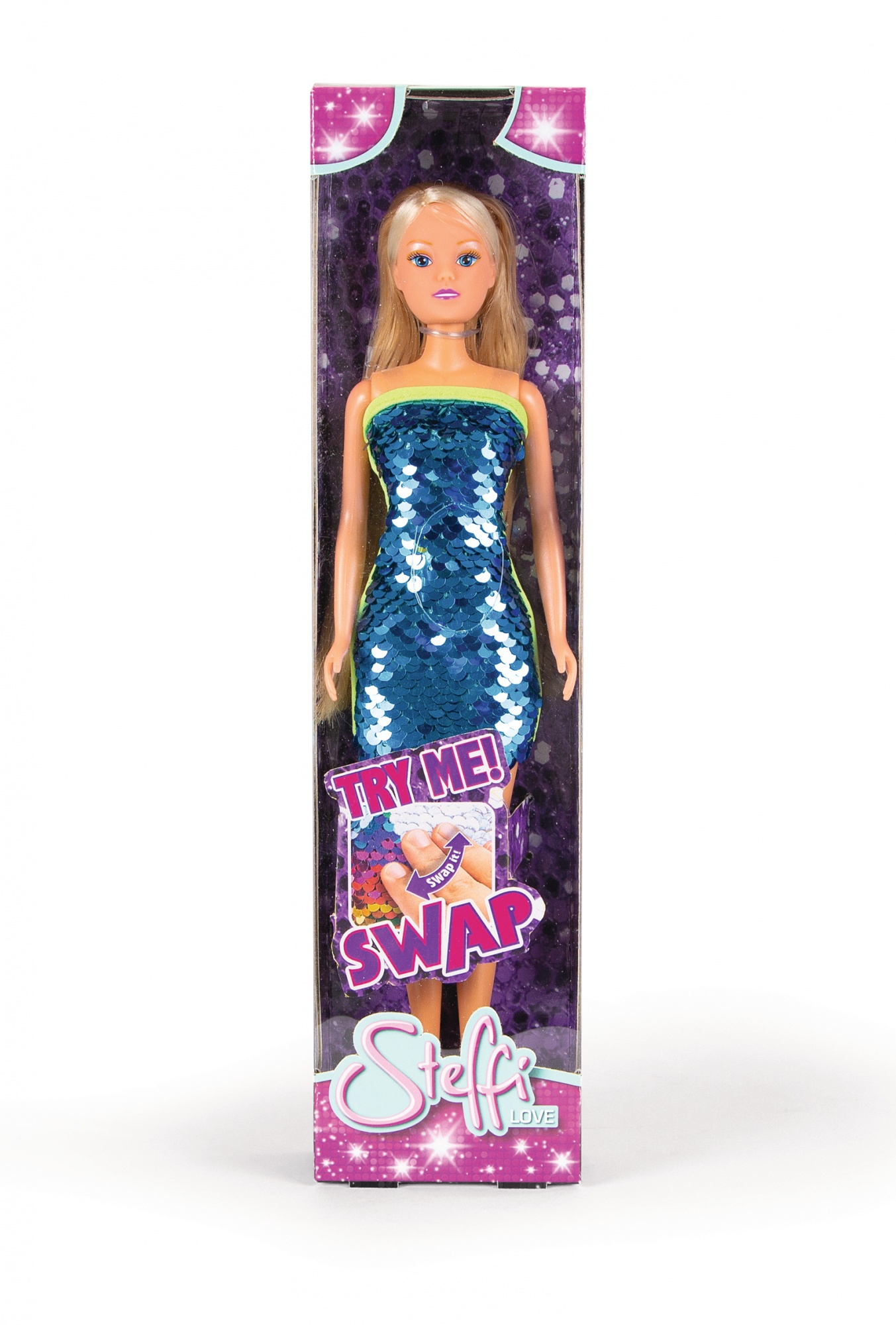 Lalka w pudełku. Lalka ma blond włosy i niebieską sukienkę z cekinami. Na pudełku napis 'Try Me!' i 'Swap'.