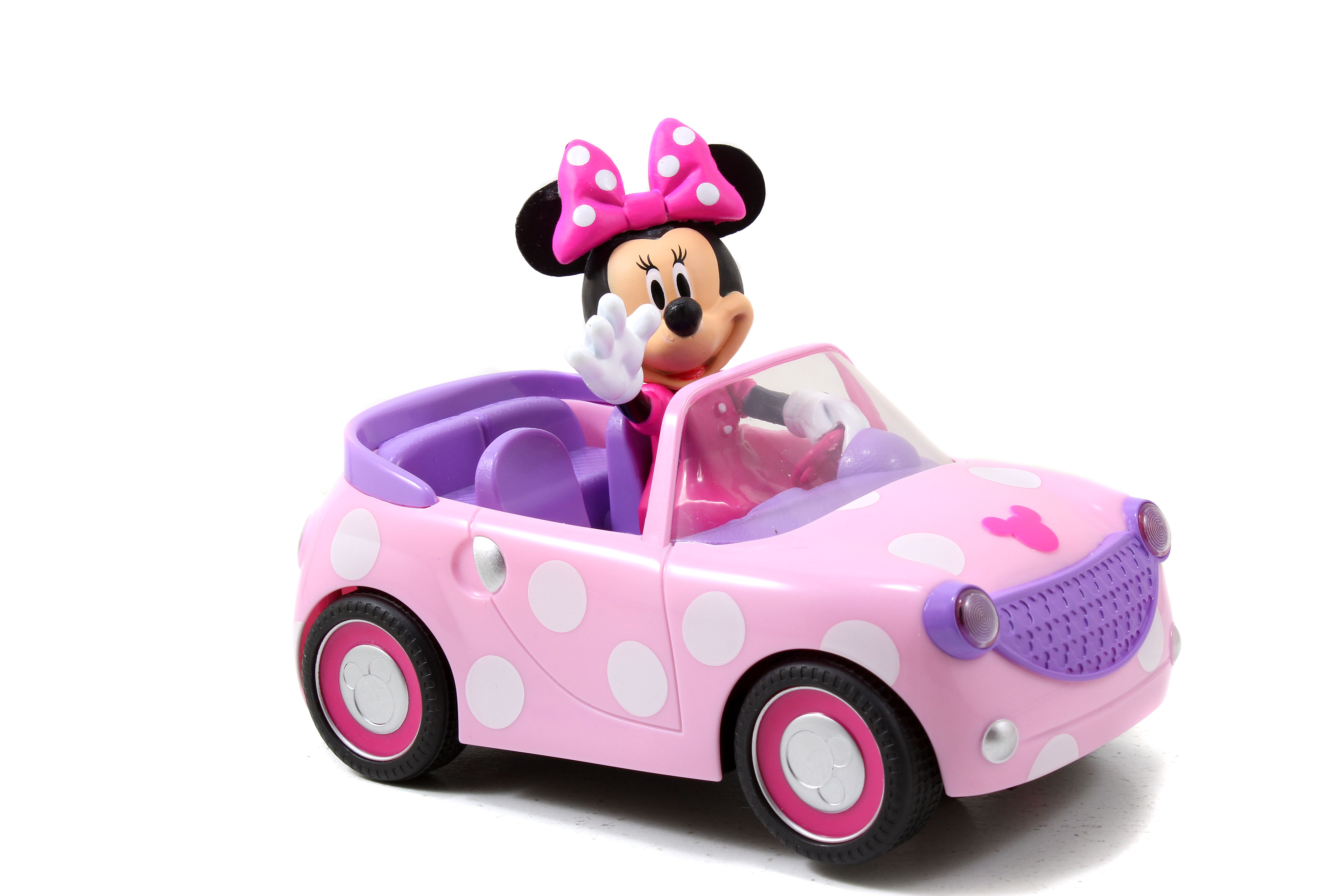 Juguete de Minnie Mouse en un coche rosa con lunares y ruedas blancas. Minnie saluda con un lazo rosa.