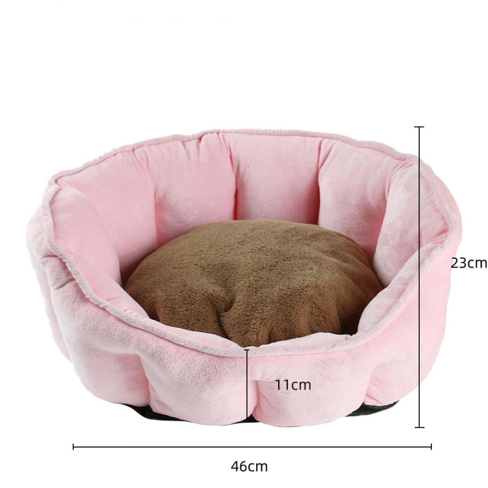 Ein rosa Haustierbett mit einem braunen Kissen darin. Die Abmessungen sind beschriftet: 46 cm breit, 23 cm hoch und 11 cm tief.