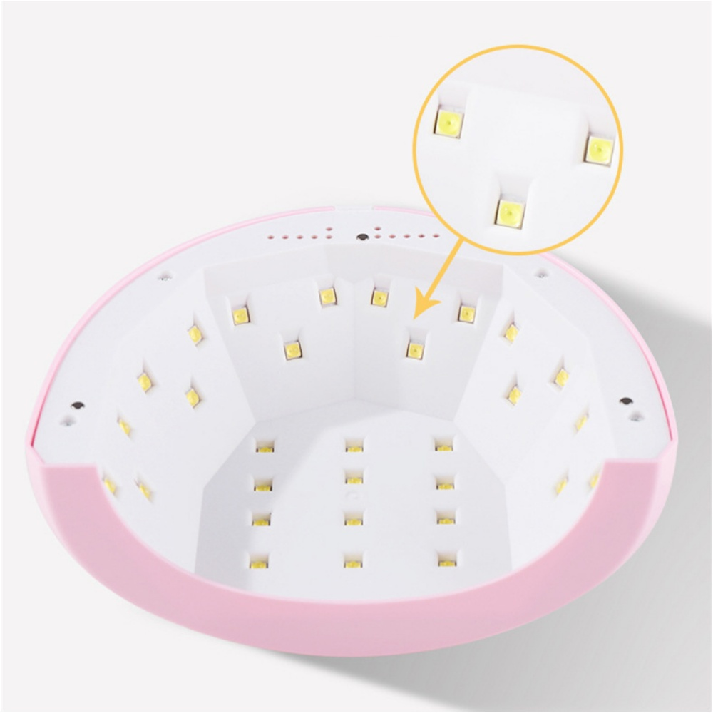 Eine rosa-weiße Nagellampe mit mehreren gelben LED-Leuchten im Inneren. Ein vergrößerter Kreis zeigt das Lichtdetail.