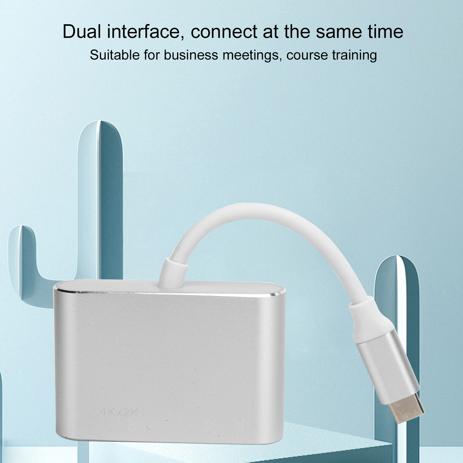 Ein silberner Adapter mit weißem Kabel ist angeschlossen. Der Hintergrund hat blaue abstrakte Formen und Text über Dual-Schnittstelle.