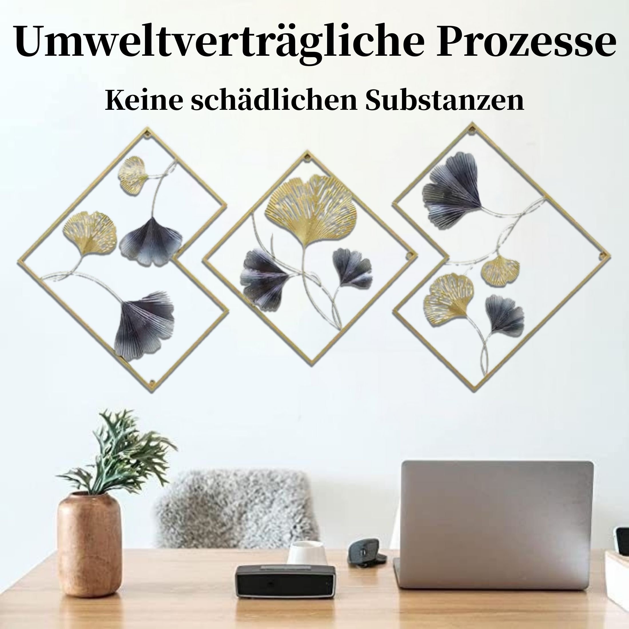 Wanddekoration mit Ginkgoblättern in Gold und Grau, Schreibtisch mit Pflanzenvase, Laptop und Lautsprecher.