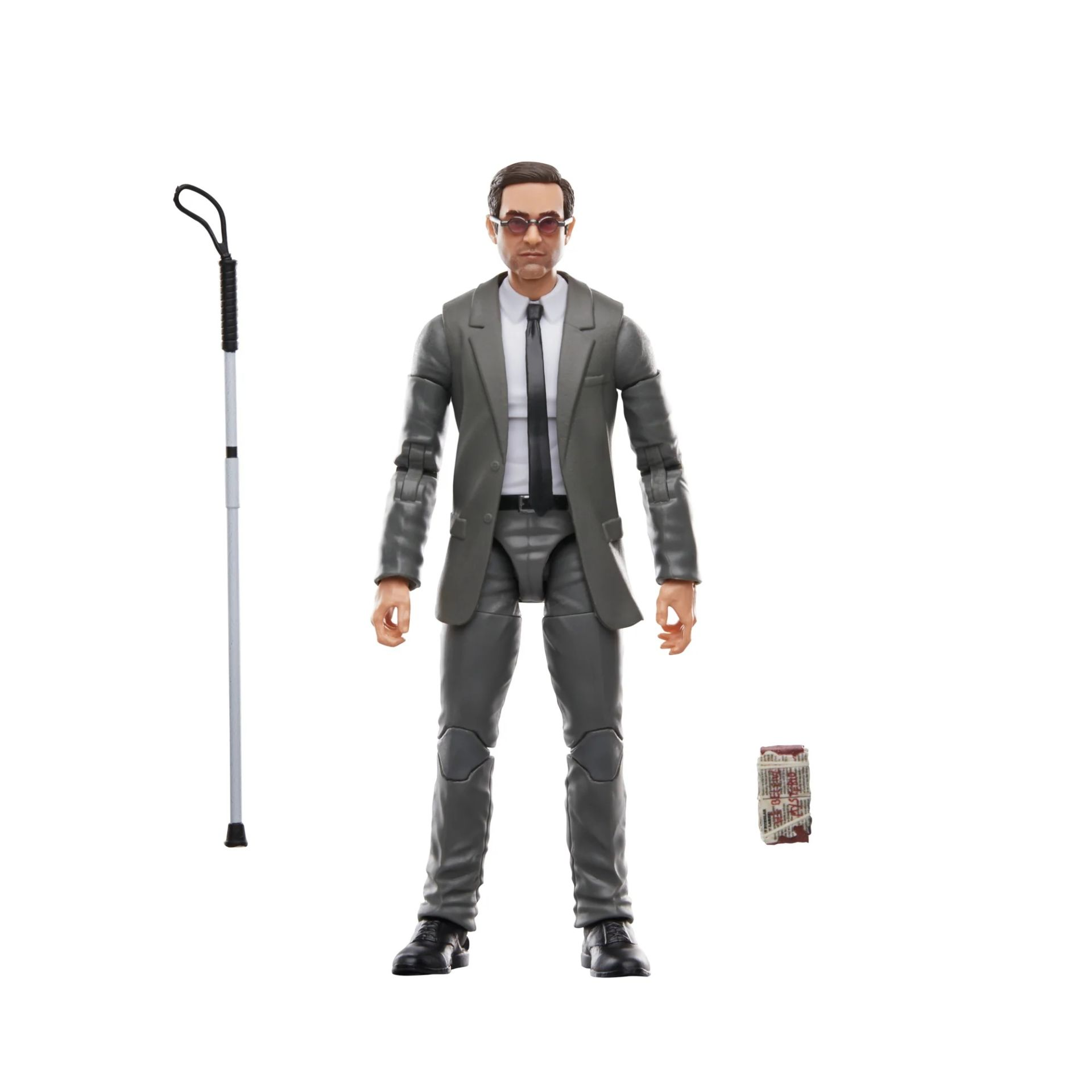 Figura de un hombre con traje gris y gafas de sol, con un bastón. Un pequeño fardo de periódico a la derecha.