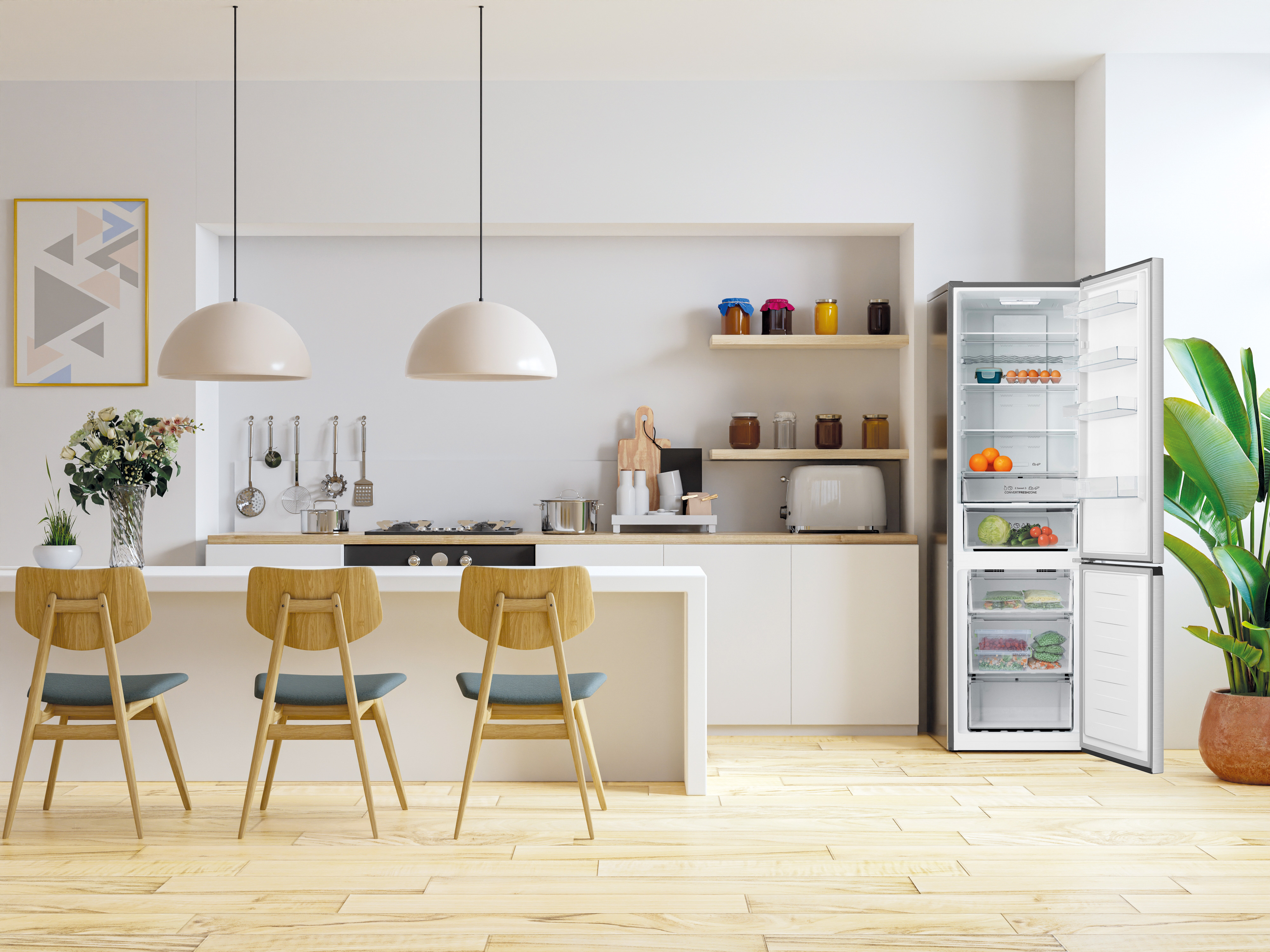 Cocina moderna con isla, sillas, nevera abierta y plantas. Contiene pisos de madera, gabinetes blancos y elementos decorativos.