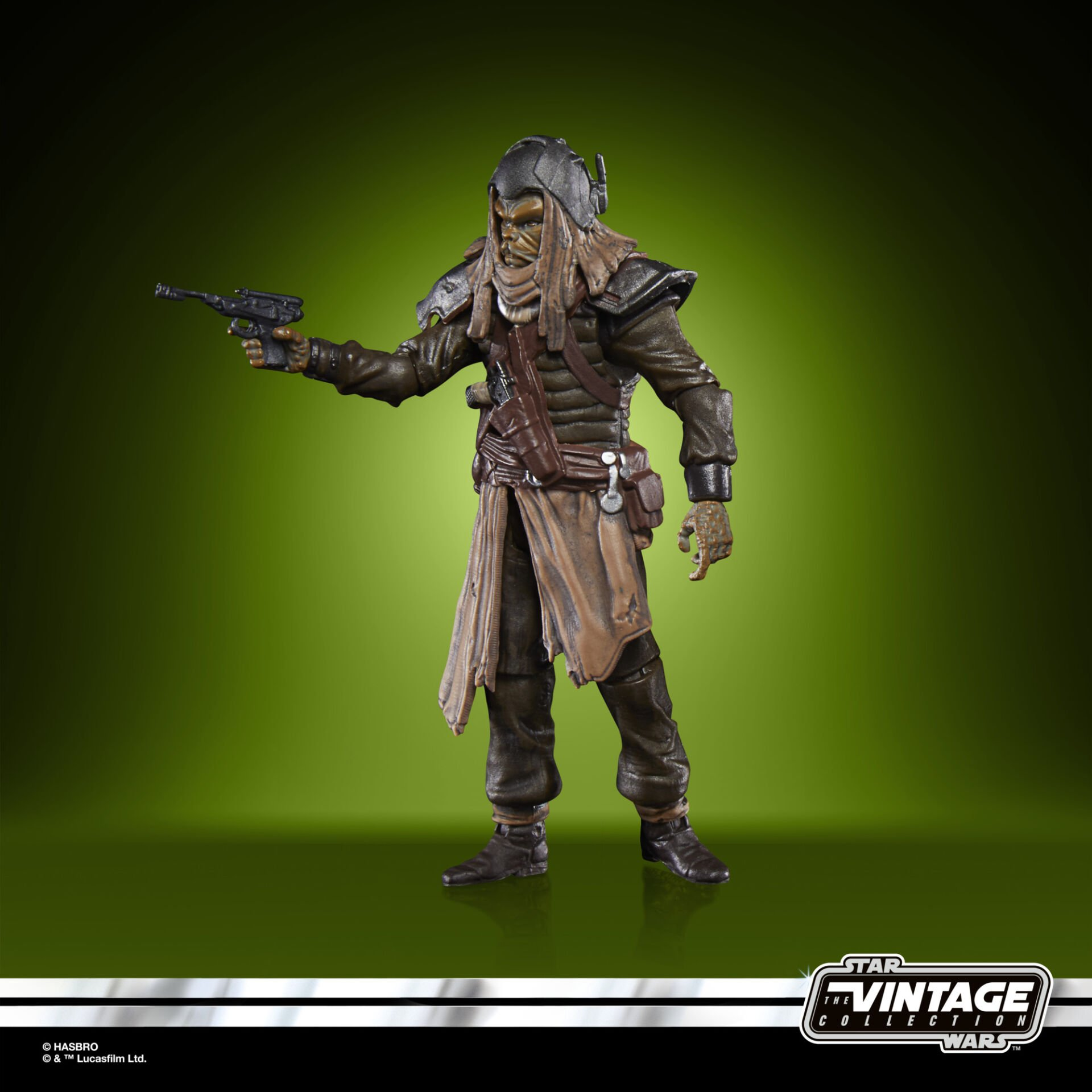Bir Star Wars figürü bir patlayıcı tutuyor. Kask, omuz zırhı ve yırtık bir tunik giyiyor. Arka plan yeşil bir geçiş.