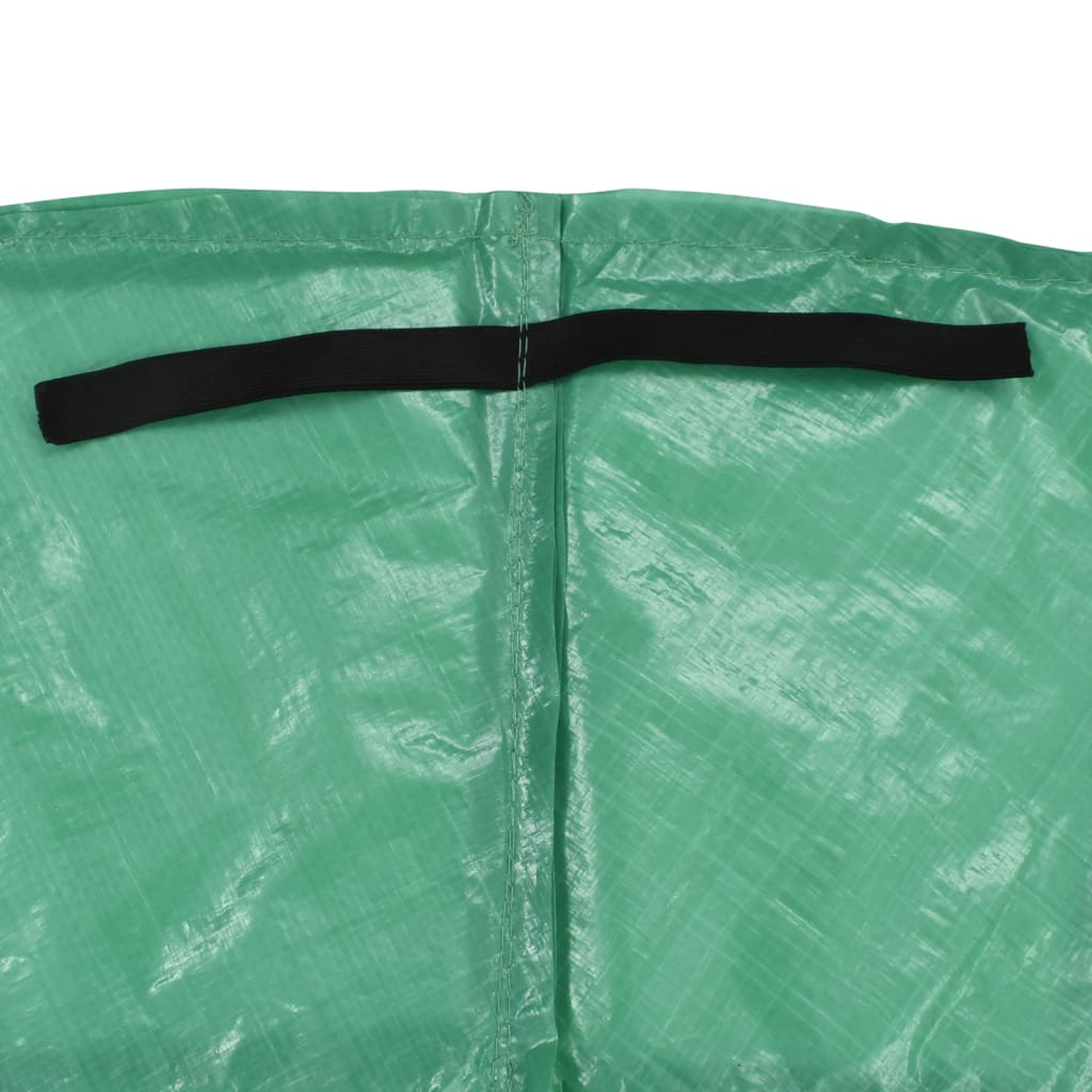Primo piano di un tessuto verde strutturato con una fascia elastica nera in alto. Cucitura verticale al centro.