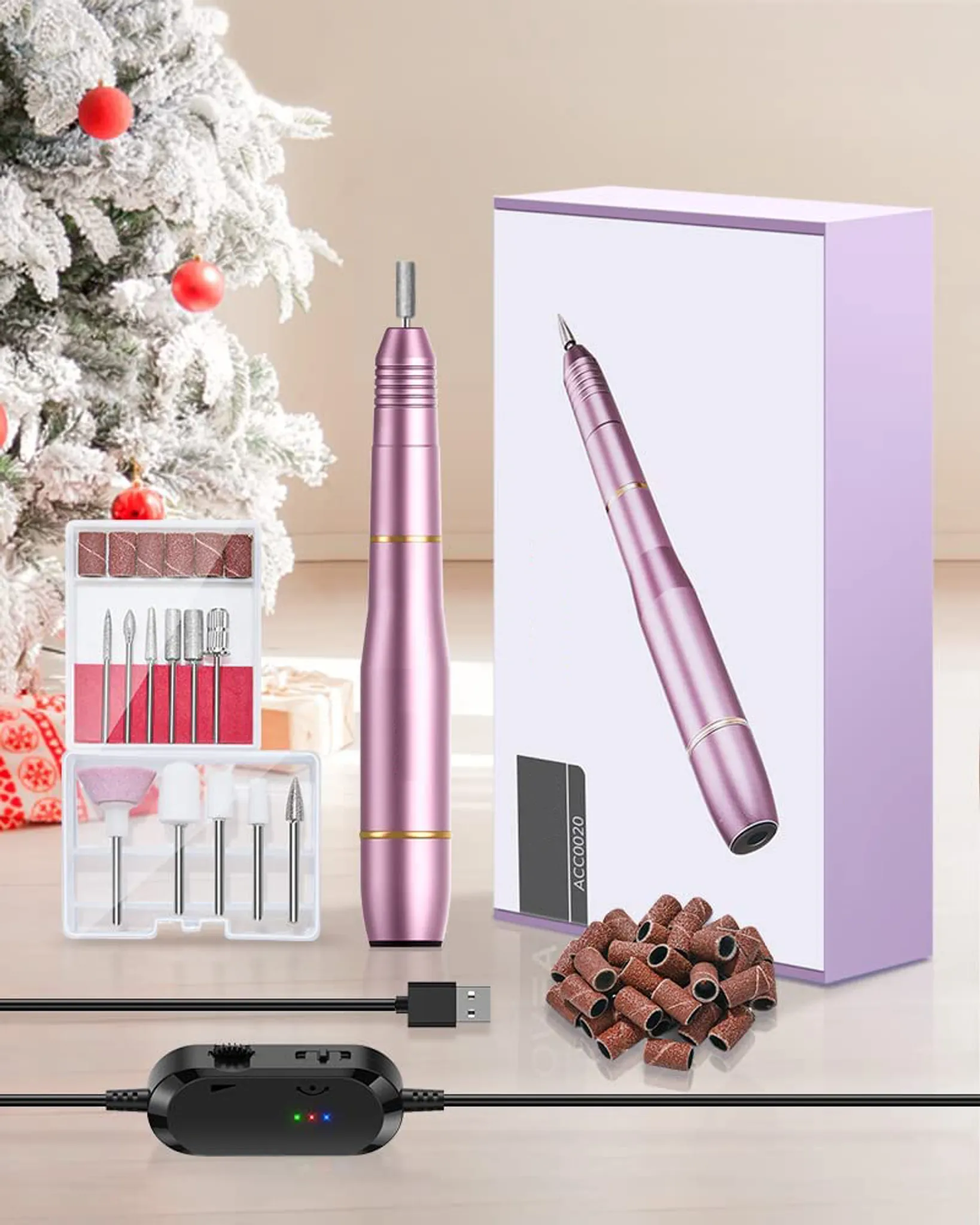 Eine rosa Nagelfräse und Zubehör werden gezeigt. Im Hintergrund befindet sich ein Weihnachtsbaum.