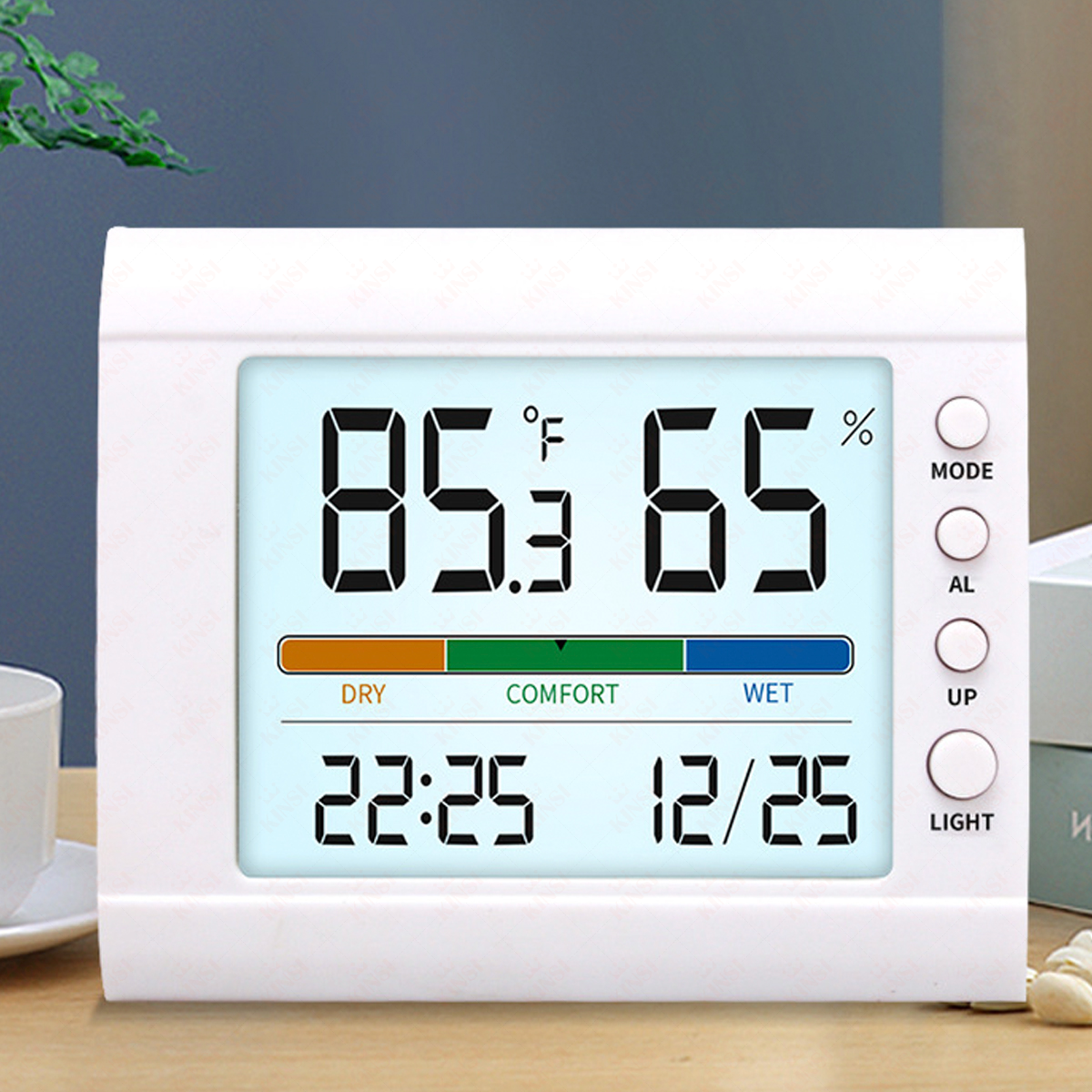 Digitales weißes Thermometer zeigt Temperatur und Luftfeuchtigkeit. Zeigt 85,3 °F und 65 %. Tasten: Modus, AL, UP, Licht. Komfortlevel ist grün.