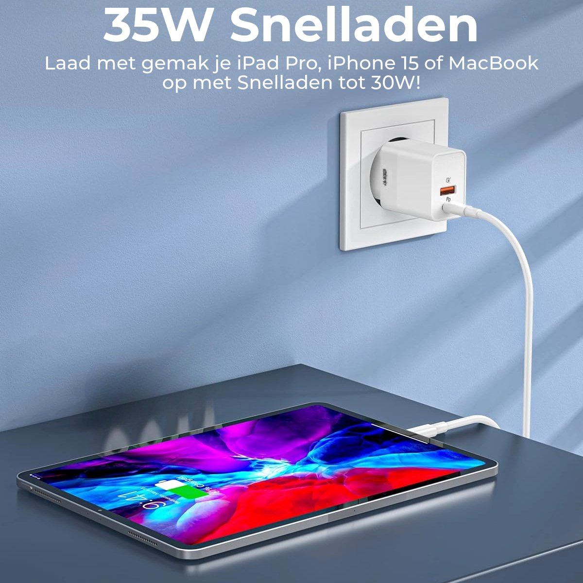 An iPad charging with a white charger plugged into a wall socket. The iPad is on a table.