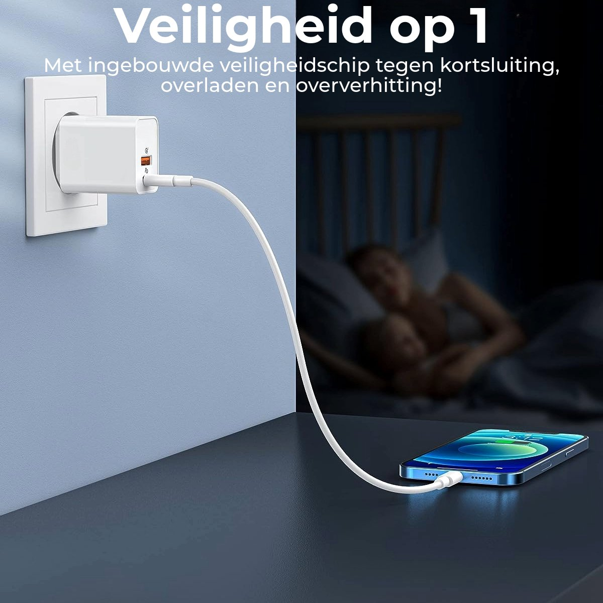 A white phone charger is plugged into a wall. A phone is charging on a dark table. Blurred figures of people in the background.