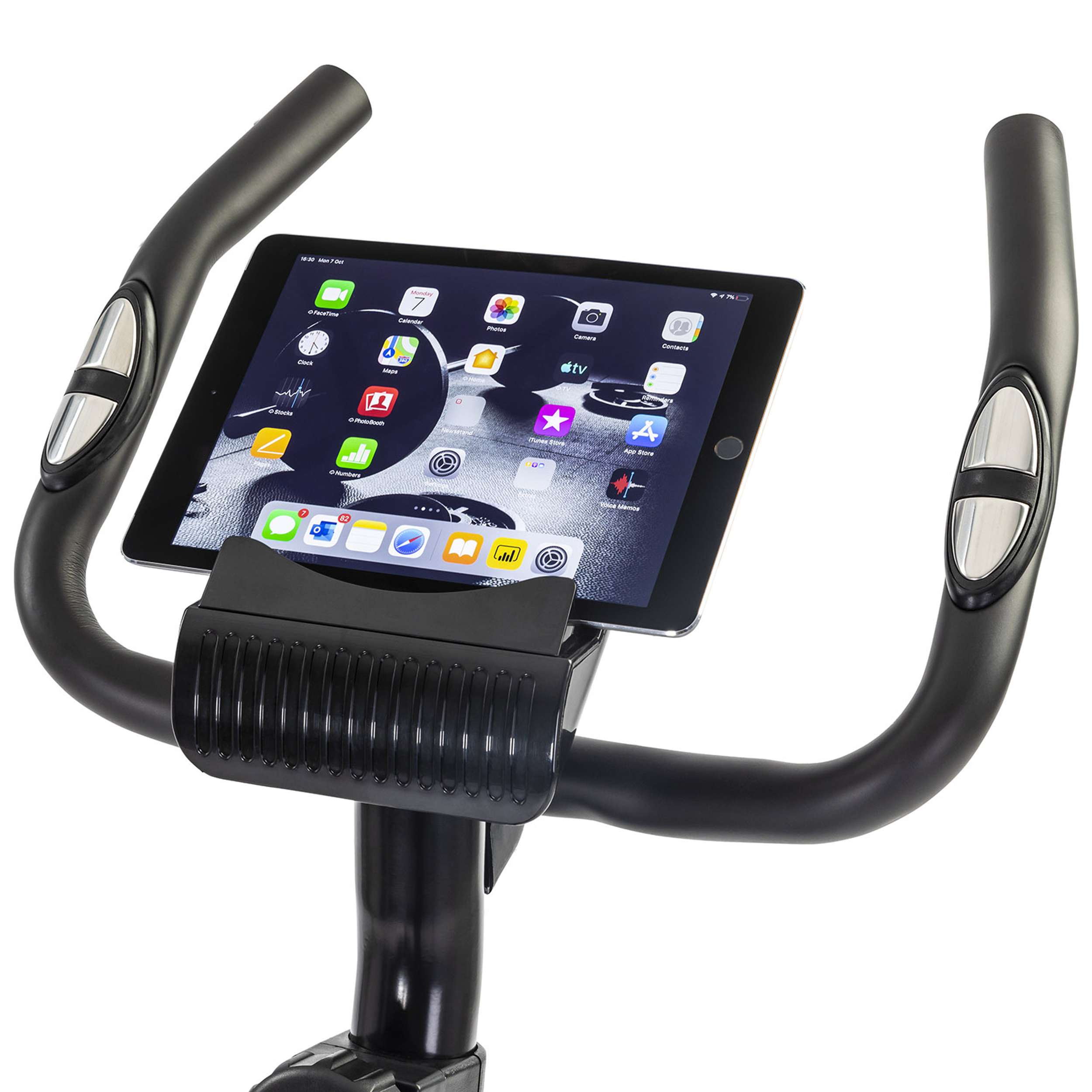 Stationary bike handlebars with an iPad displaying app icons. The handles are black and have silver buttons.